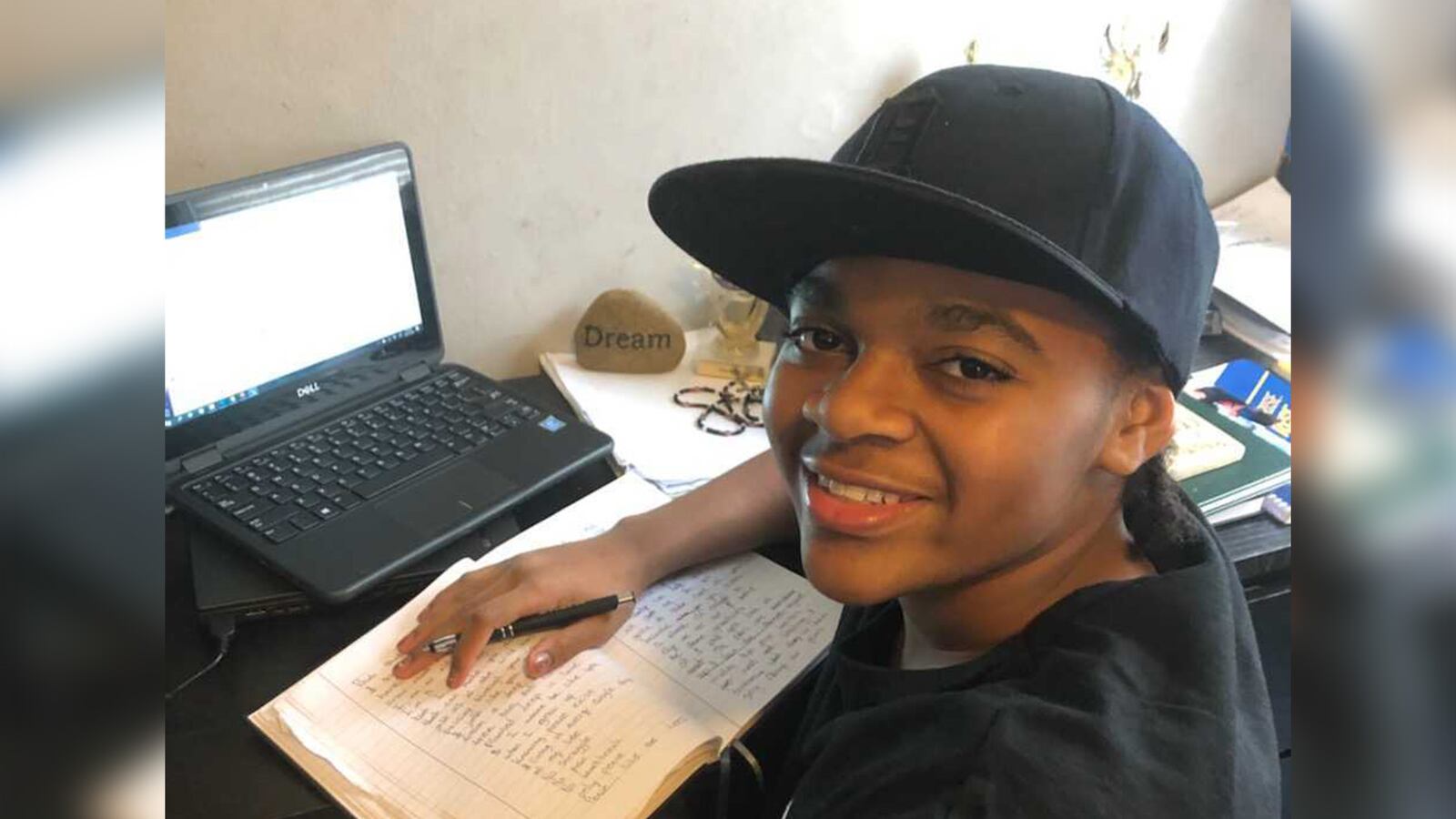 King Bethel smiling at his desk at home.