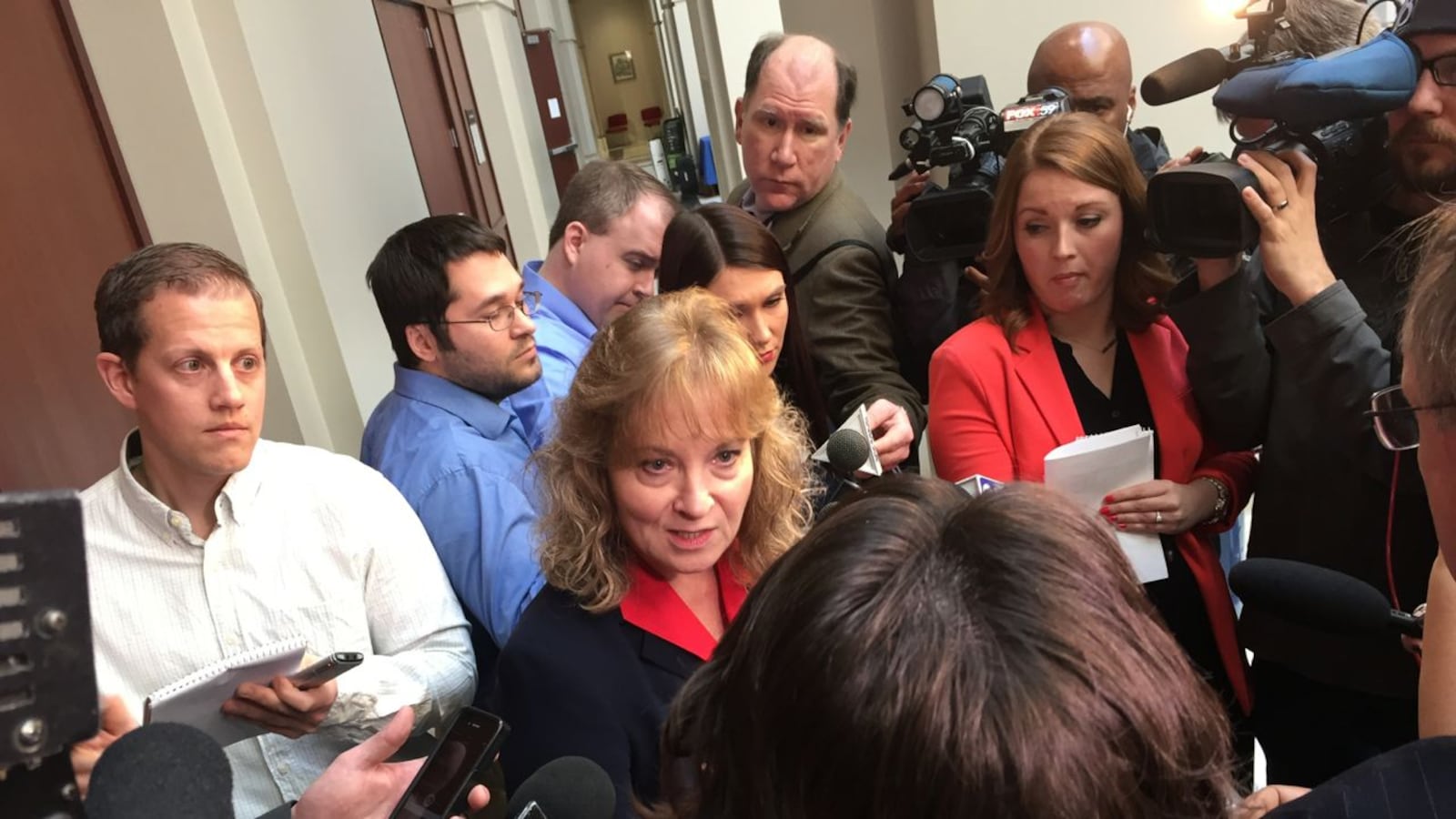 State Superintendent Glenda Ritz is surrounded by reporters after an Indiana State Board of Education meeting last year.