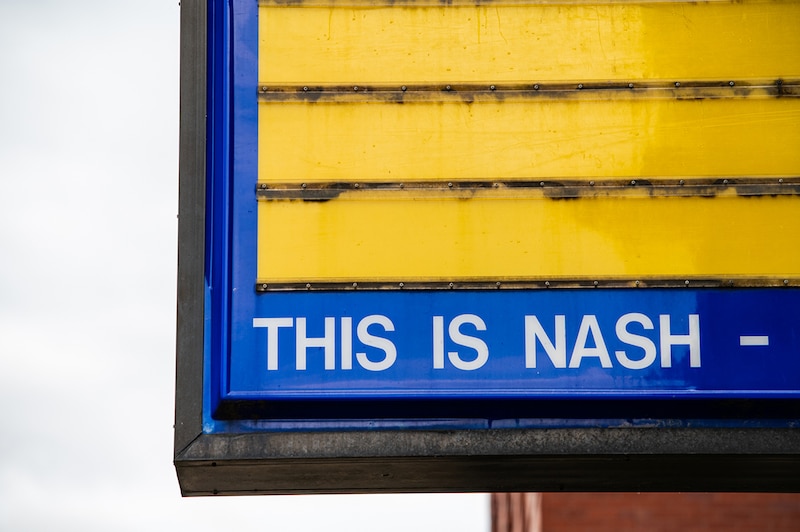 A blue and yellow school sign.