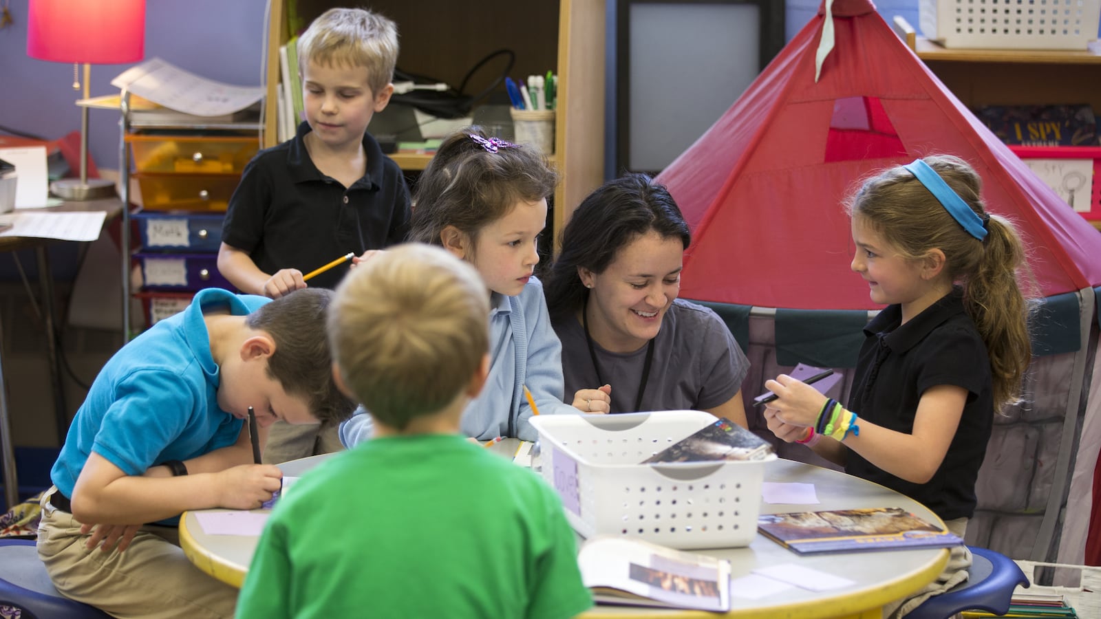Students work with a teacher at IPS #84, Indianapolis, Wednesday, May 18, 2016. Ethnically, the Center for Inquiry School 84 is one of the least diverse in the IPS system, and enrollment priority is given to kids living near its Meridian-Kessler location.