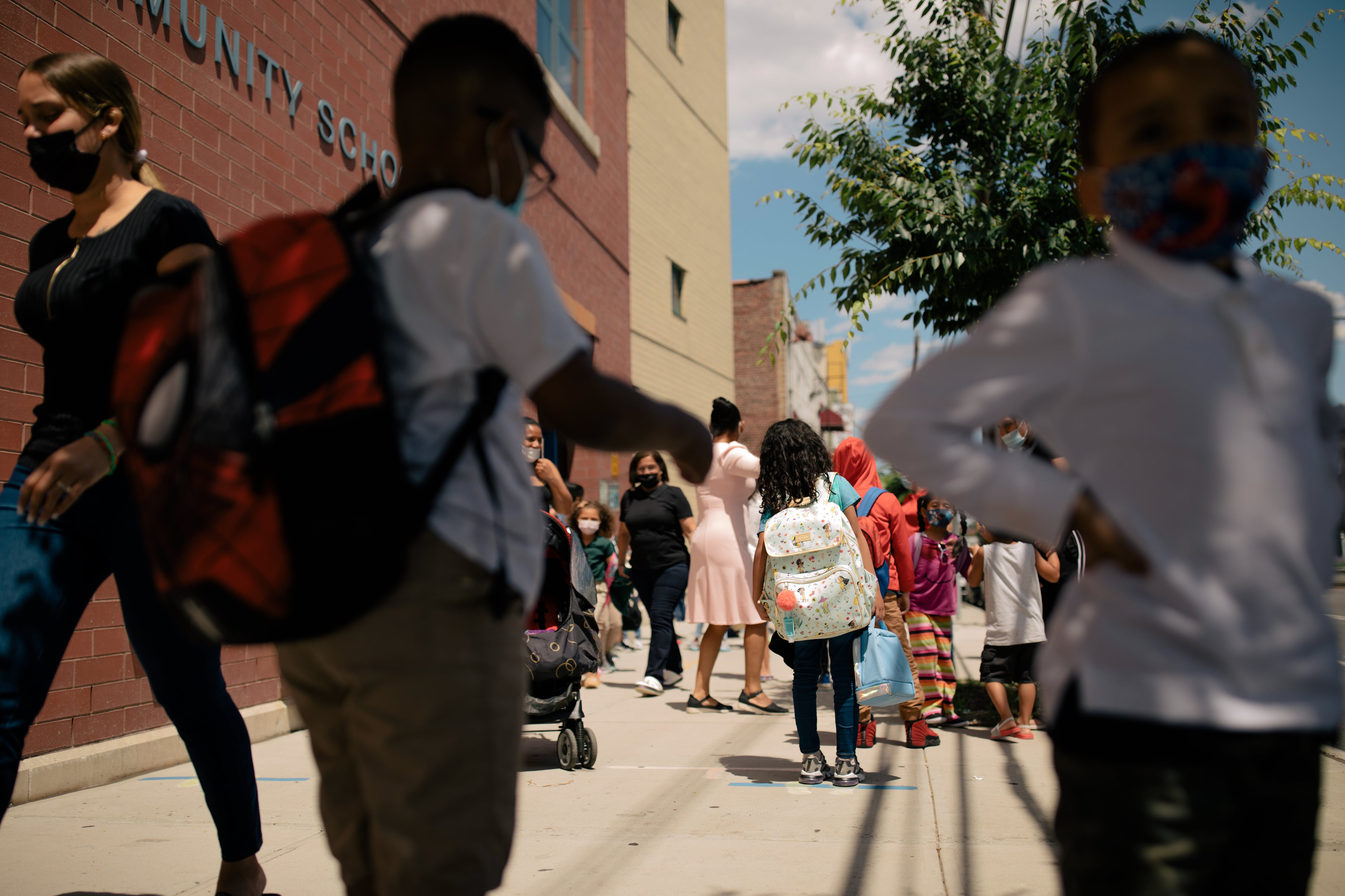 Students and parents walk by P.S. 89 on a beautiful June day.
