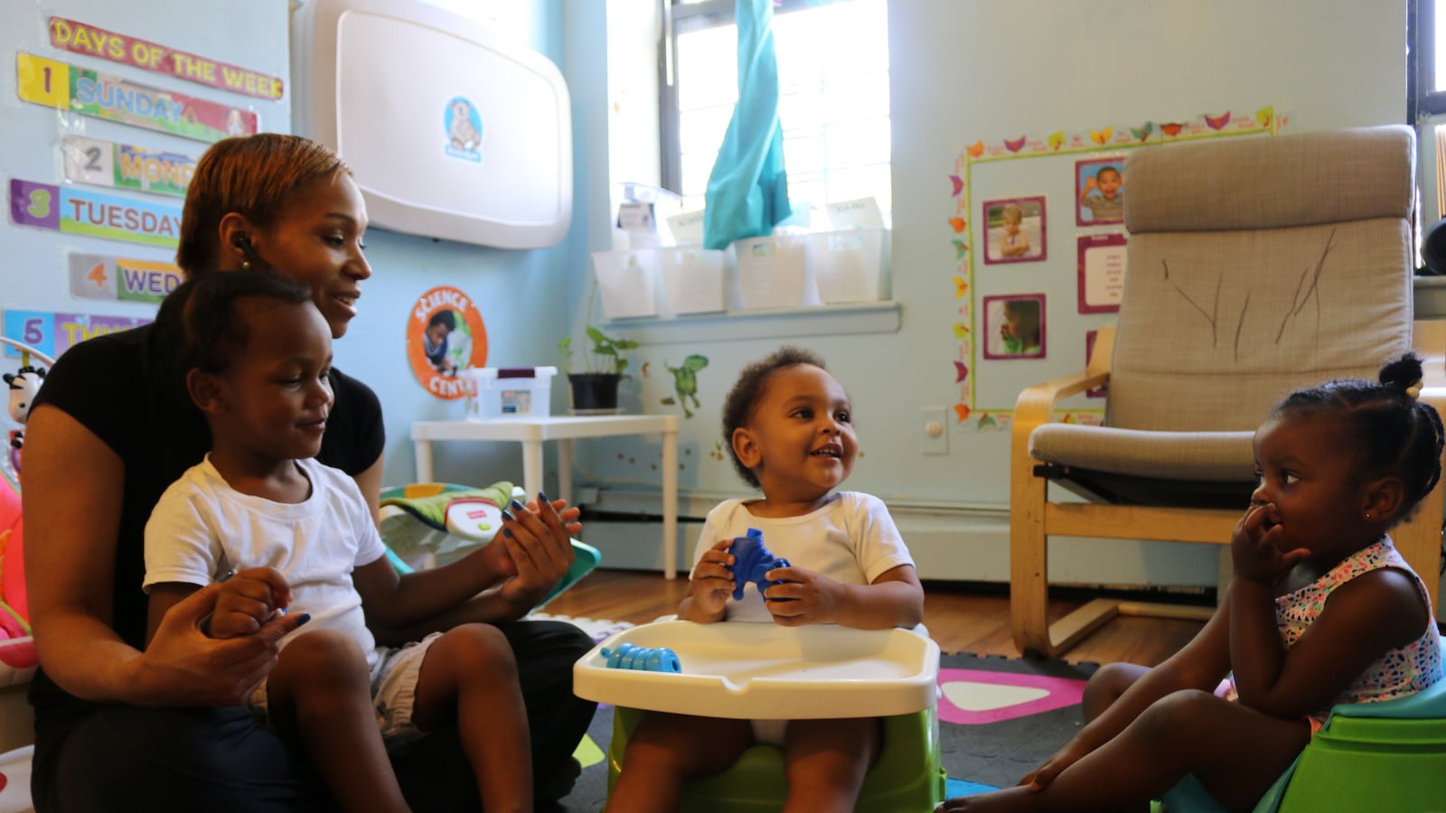 Sherease Alston sings along with children at her child care center, Little Minds at Work.