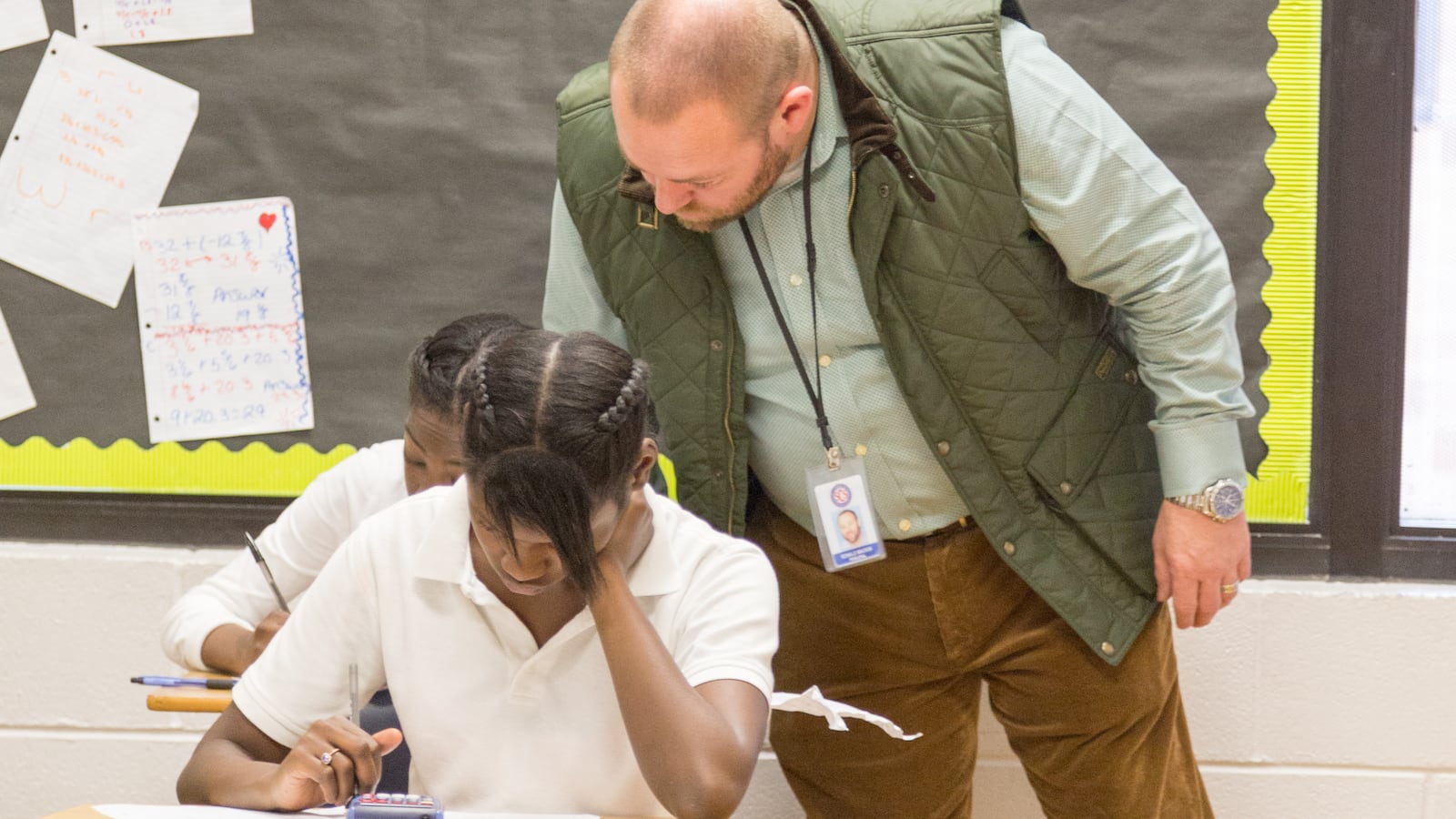 Ronnie Mackin checks on a student's work in 2016 when he was principal at Raleigh Egypt Middle School. Mackin was chief administrator the following school year at Trezevant High School, now the center of several investigations that started as a result of Mackin's allegations.