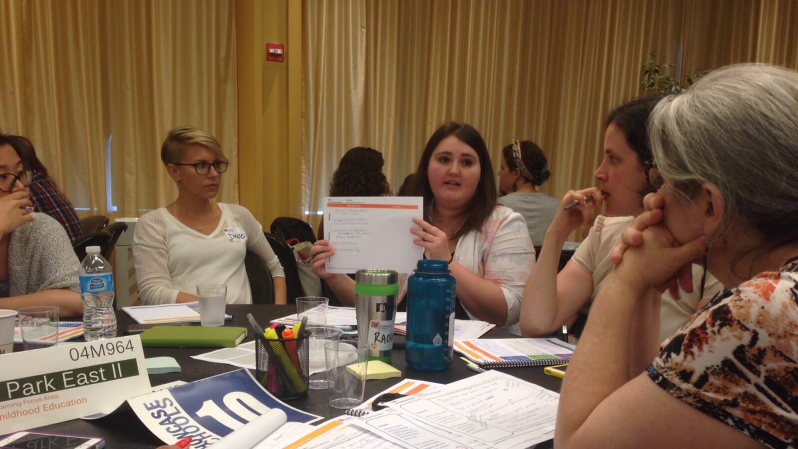 Christina Cordell, a director for the Showcase Schools program, works with Central Park East II Principal Naomi Smith, right, at conference on Tuesday.
