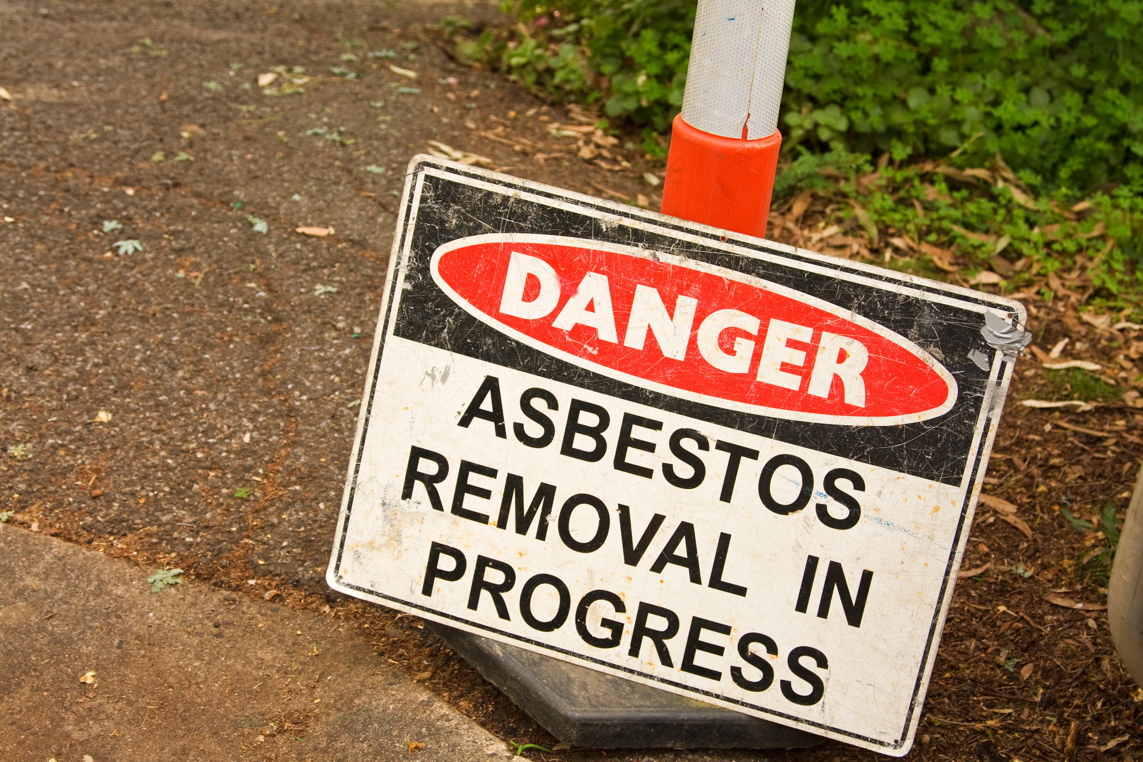 A sign that says “Danger. Asbestos Removal In Progress.”