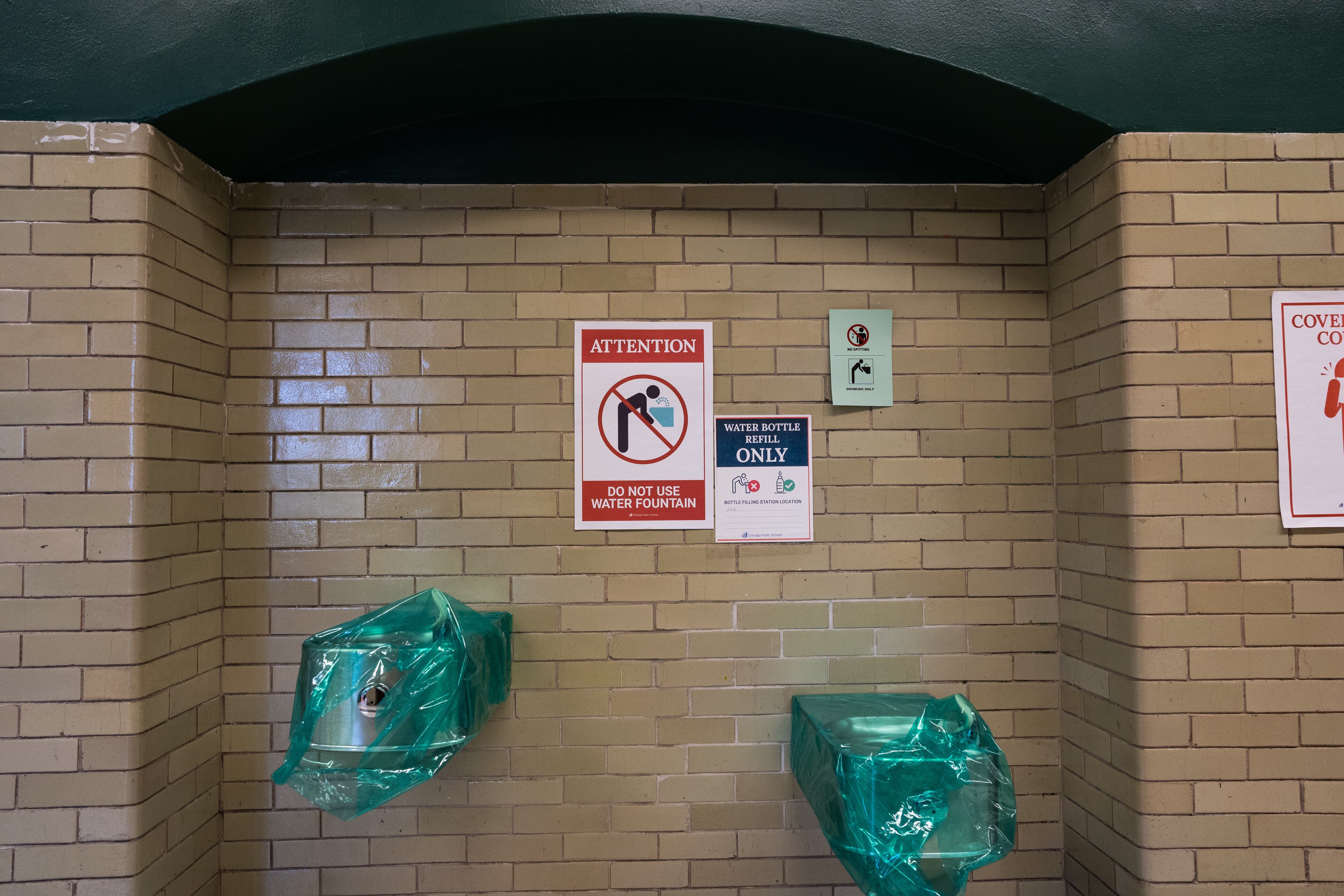 Water fountains are seen covered at Senn High School on the first week back to classrooms for students on April 23, 2021.