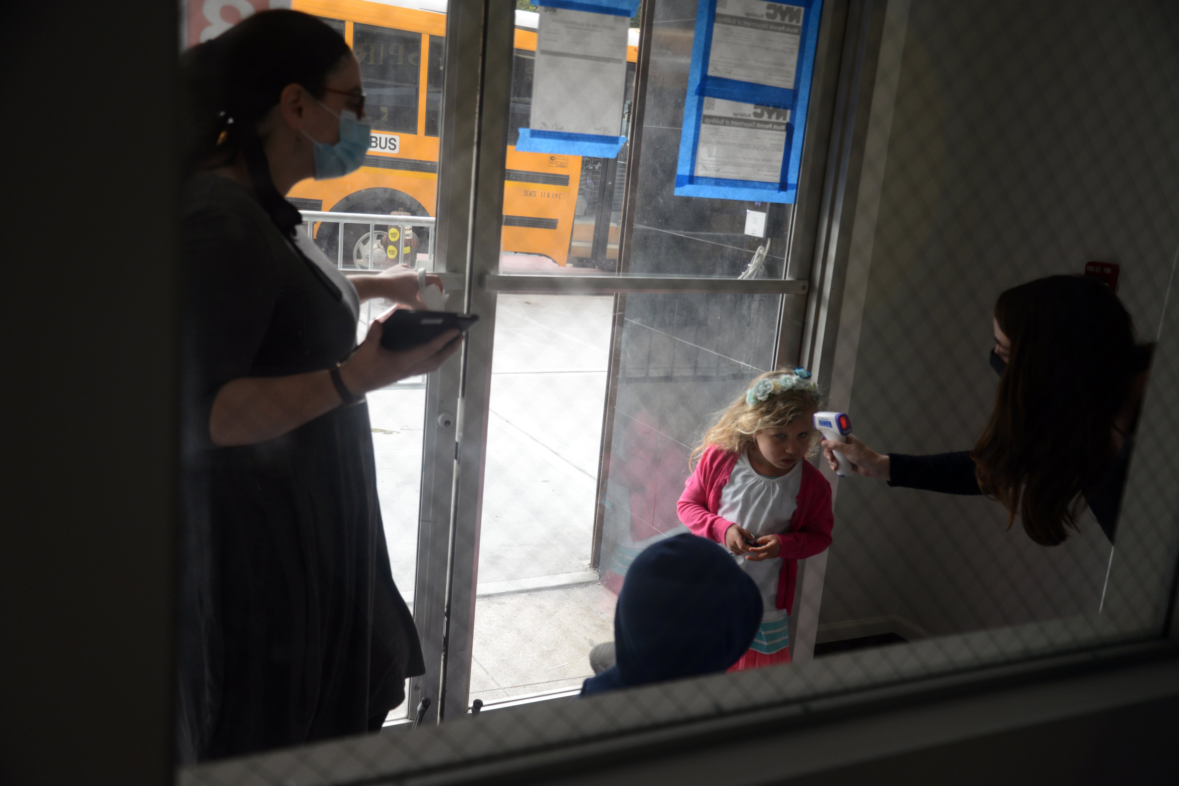 A COVID vaccination mandate for New York City teachers takes affect Monday, but pre-K and day care employees are still waiting to learn if they can receive a medical or religious exemption from getting the shots. Above, a student at Preschool of the Arts got their temperature checked on the first day of school this September.