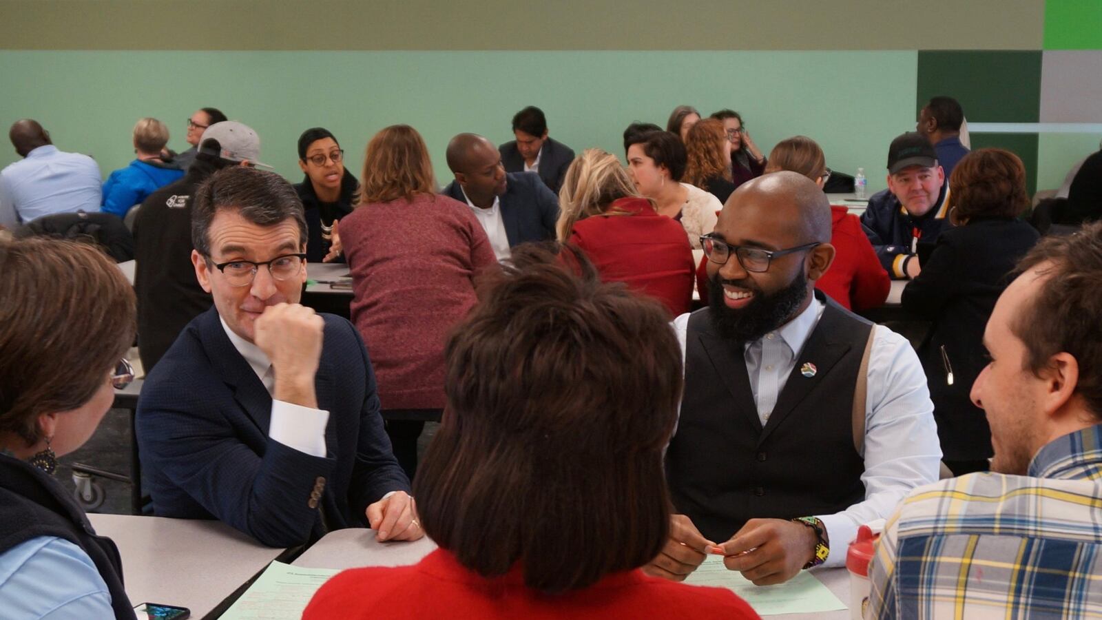 School board president Michael O'Connor, left, and IPS graduate Darius Sawyers at a community meeting about the district's next superintendent.