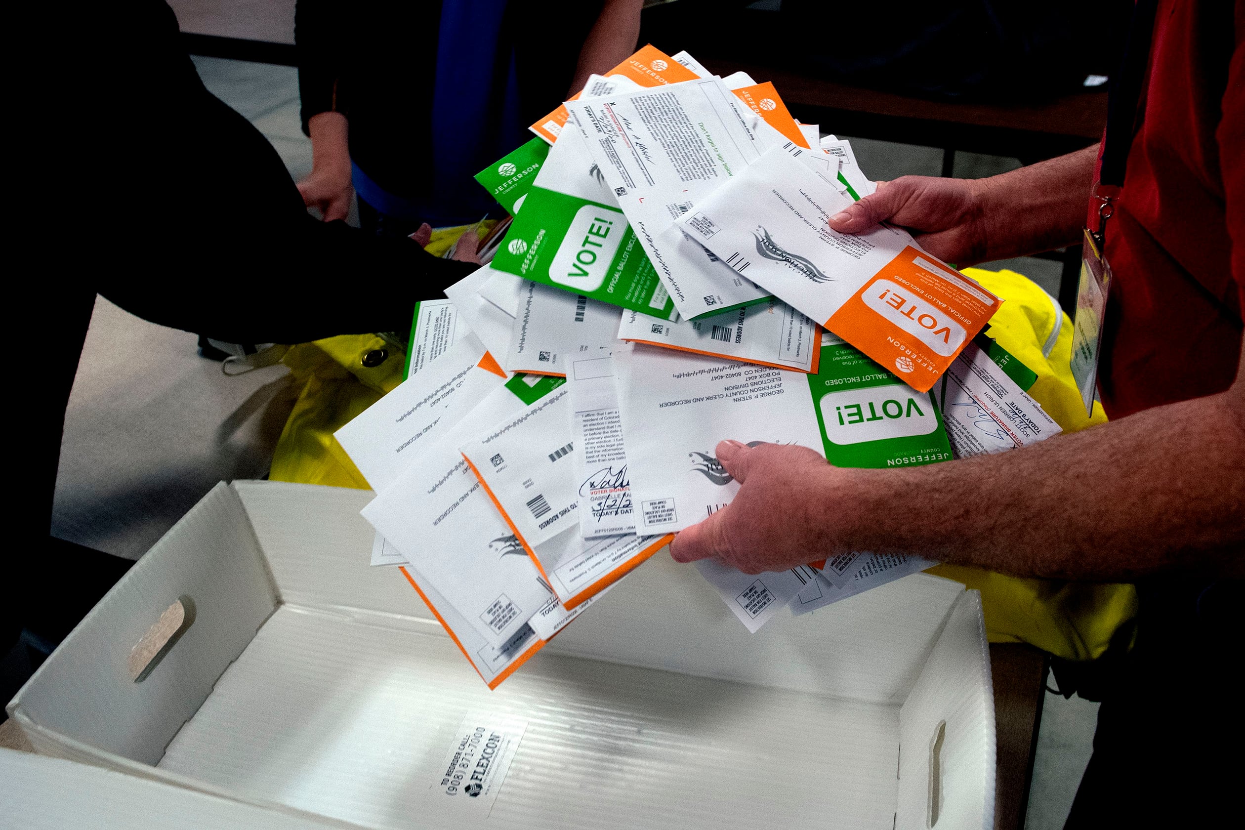A close up of ballots in a person’s hands