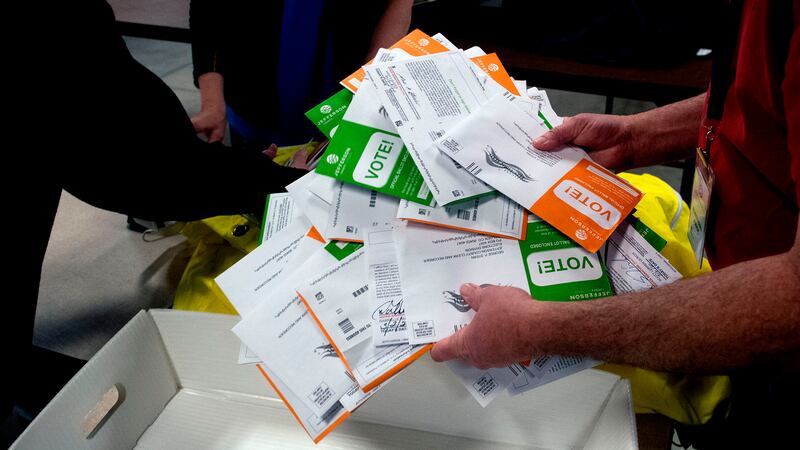 A close up of ballots in a person’s hands