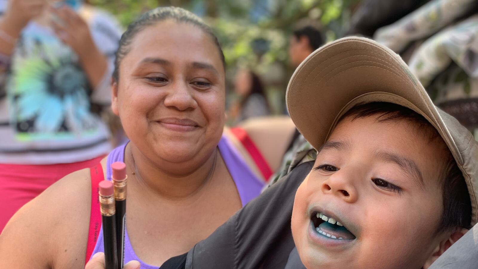 Maria Garcia and her son Leonardo wait in line for free school supplies at the first back to school bash.