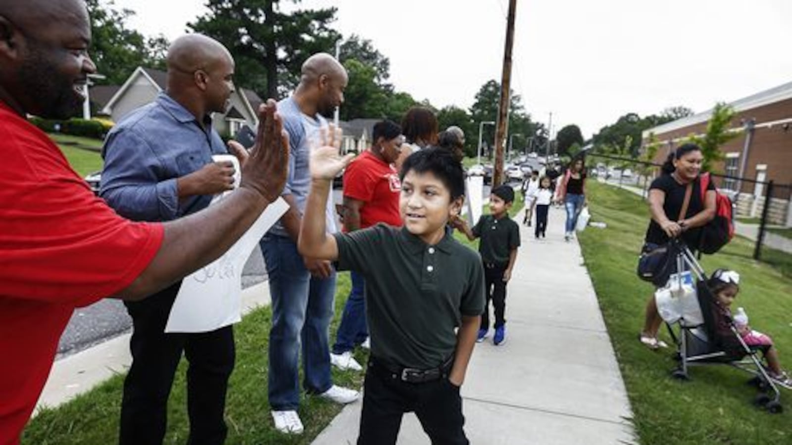 Third-grader Juan de la Cruz is welcomed back to class on Aug. 7 at Belle Forest Community School in Memphis. The back-to-school reception was organized by a neighborhood church as a show of support for students as the city's Hispanic community dealt with recent immigration arrests.