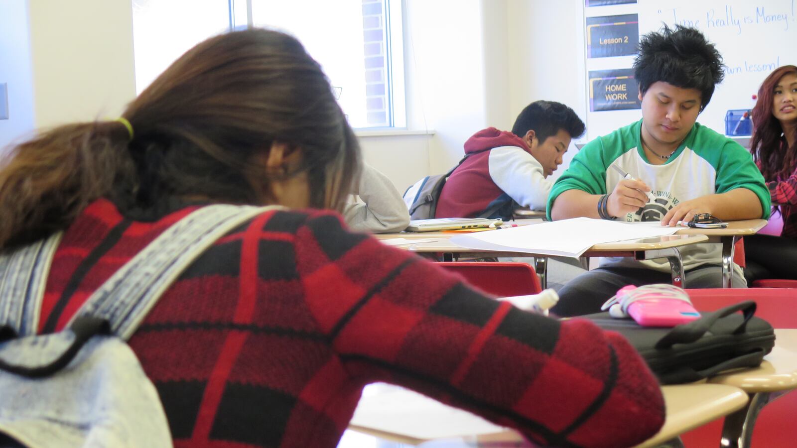 Students in an English-learner class at Southport High School work on an assignment during the last period of the day.