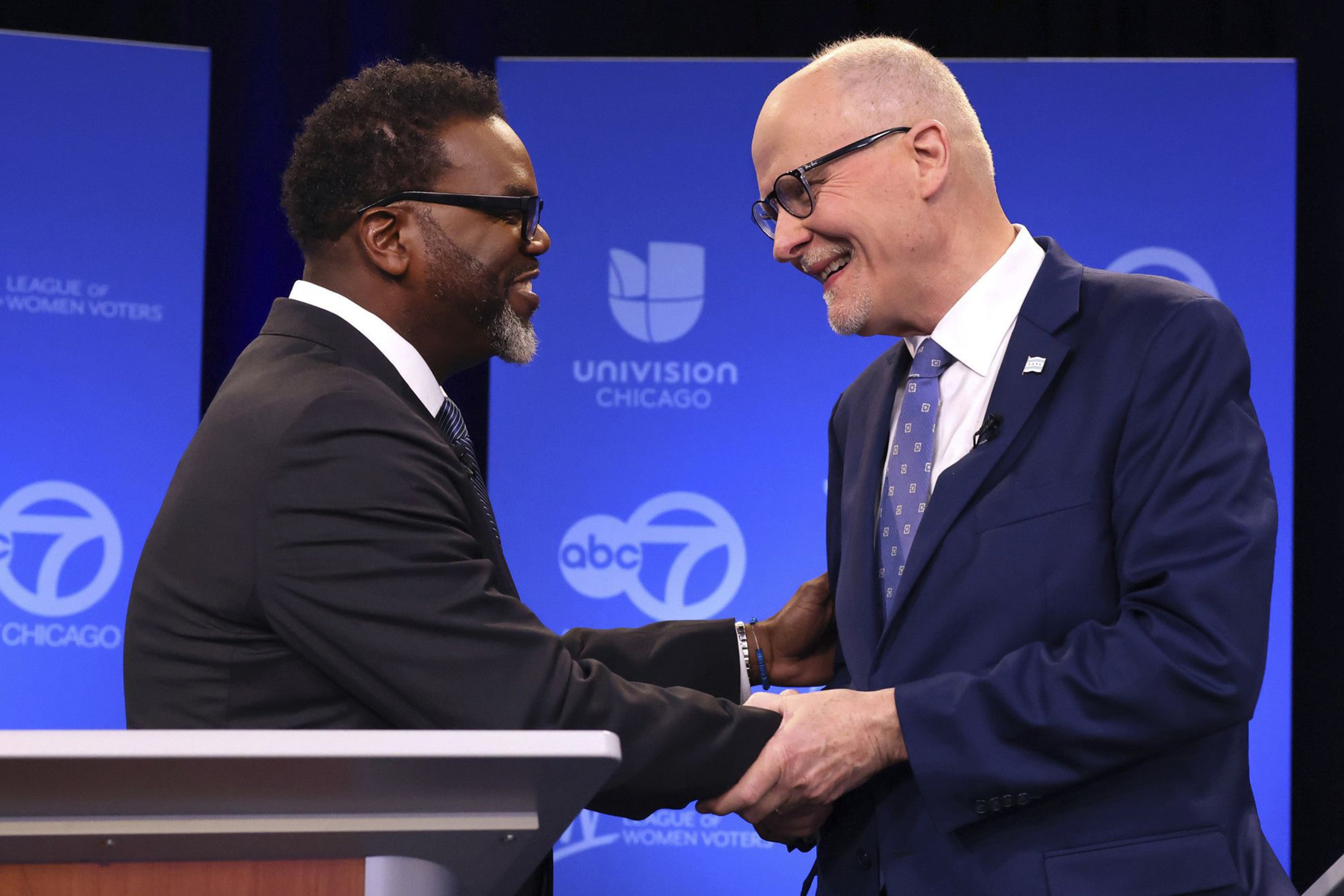Two men running for Chicago mayor shake hands after a recent forum.
