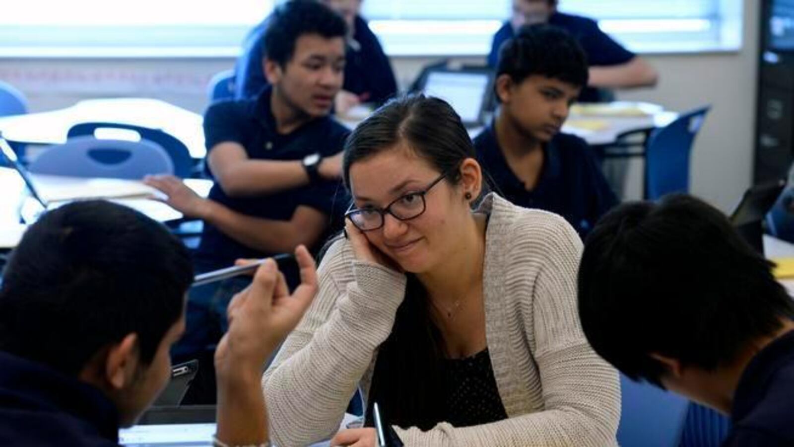 Teacher Kelly Hutchings, middle, helps students with math problems during class at Boston K-8 school in Aurora. (Photo By Helen H. Richardson/The Denver Post)