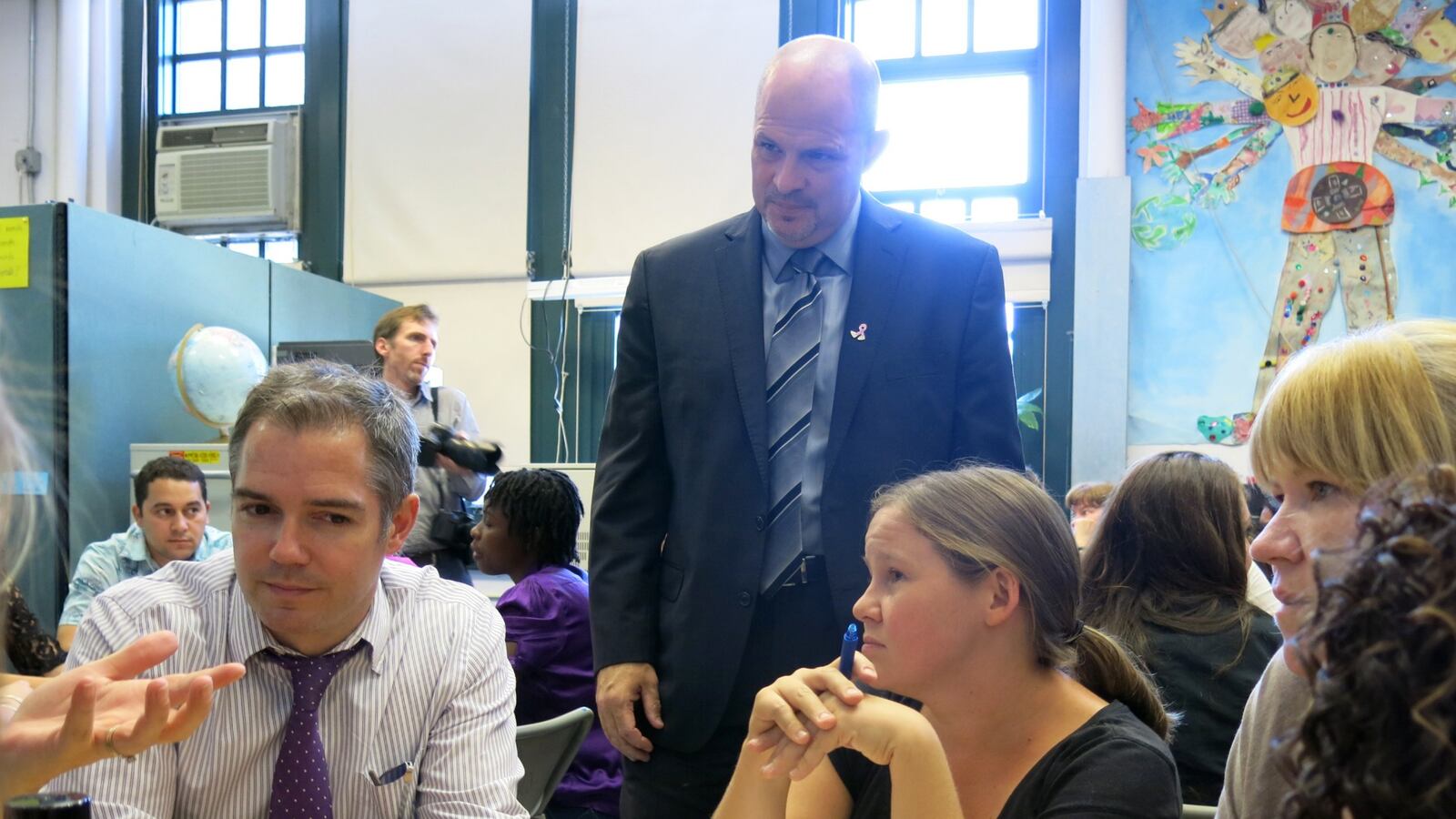 UFT President Michael Mulgrew (standing) met with teachers during a school visit in 2014.