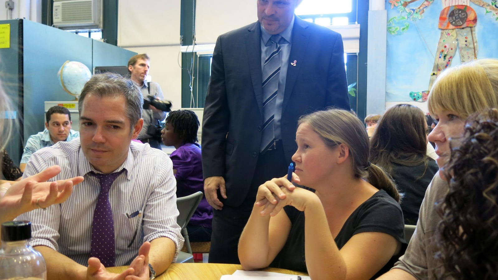 UFT President Michael Mulgrew (standing) met with teachers during a school visit in 2014.