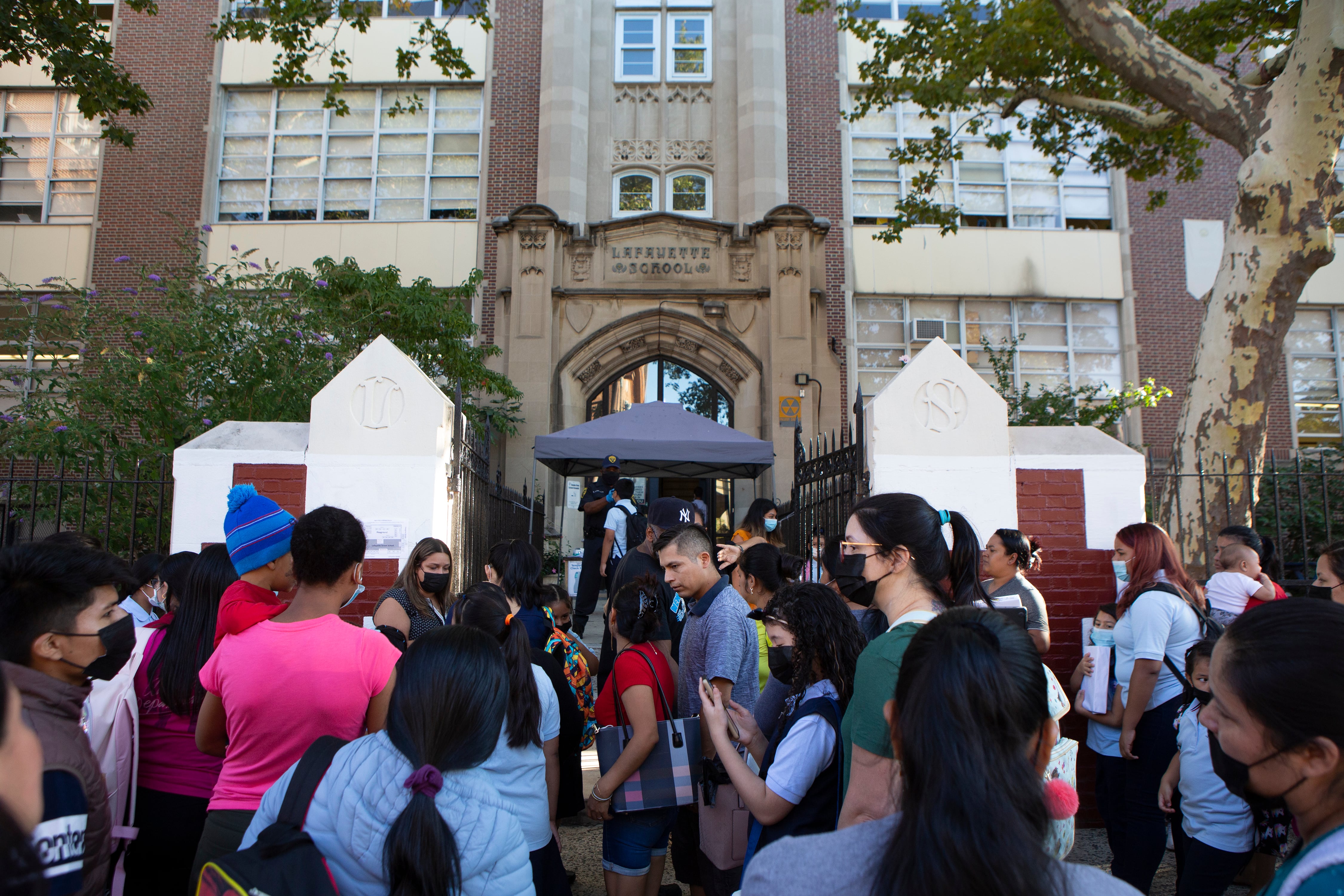 Dozens of students and parents make their way into Newark’s Lafayette Street School on the first day of classes.