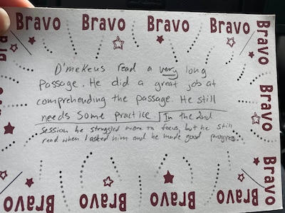 A piece of paper with the word "bravo" lines the square paper with a handwritten note in the middle.