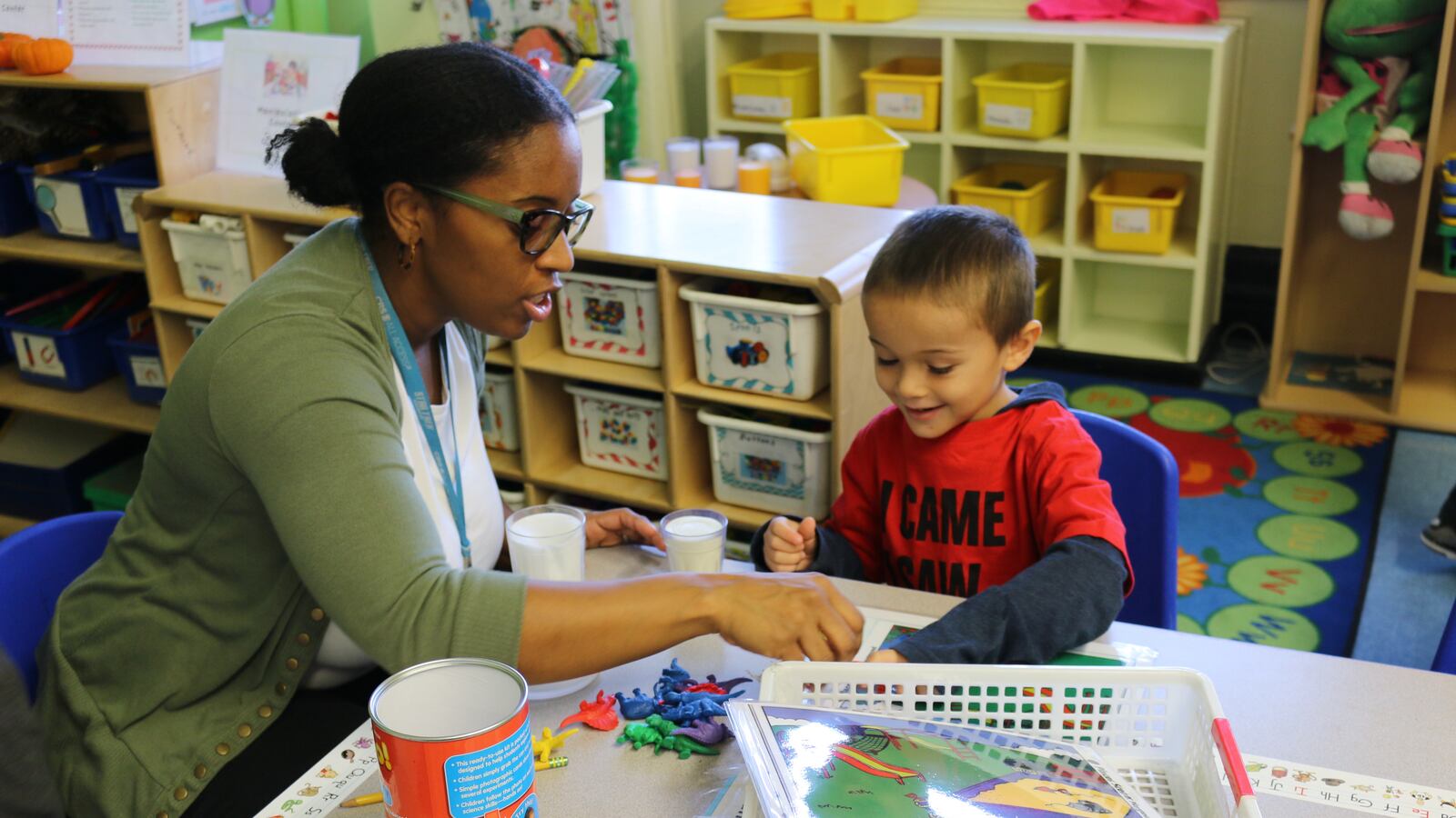 Heather Fontaine, a pre-K teacher at P.S. 277 in the Bronx, counts dinosaur toys with a student during center time.