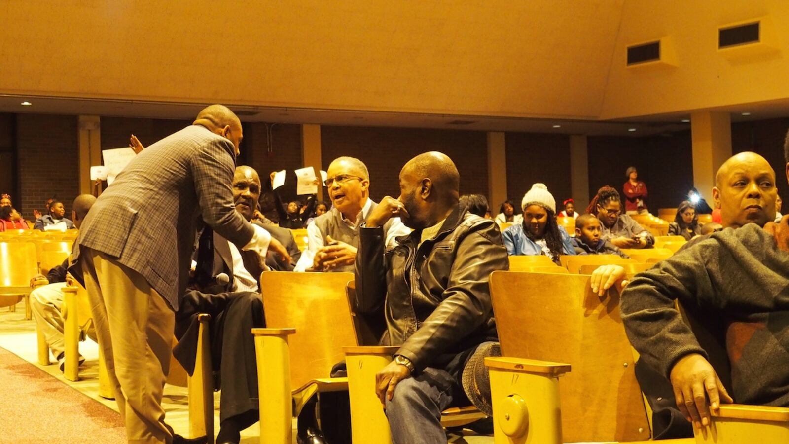 Shelby County School Board member Kevin Woods talks with a community member during a forum Monday night to discuss proposed school closures in a southwest Memphis neighborhood.