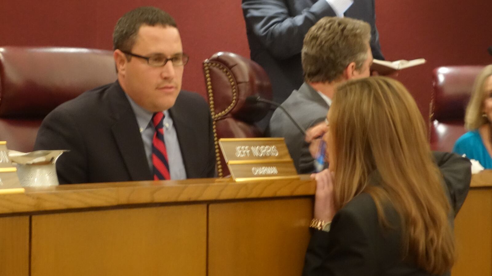 Board Chair Jeff Norris consults with Barlett' City Schools' attorney, who along with six other attorneys, will be responsible for drafting the new health policy that the board passed this evening.