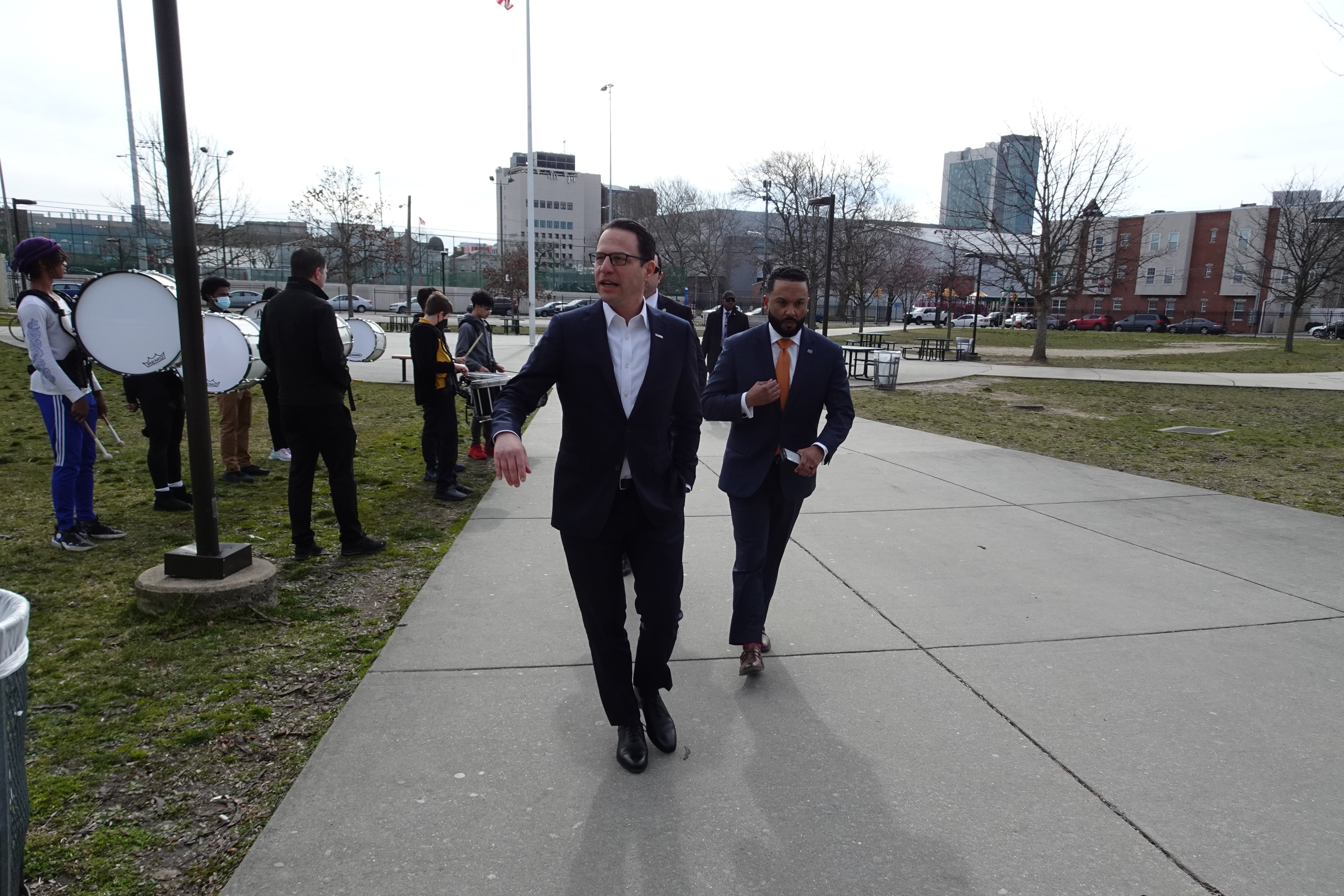 Governor Josh Shapiro walks with another person during a tour of George Washington Carver High School for Engineering & Science in Philadelphia.