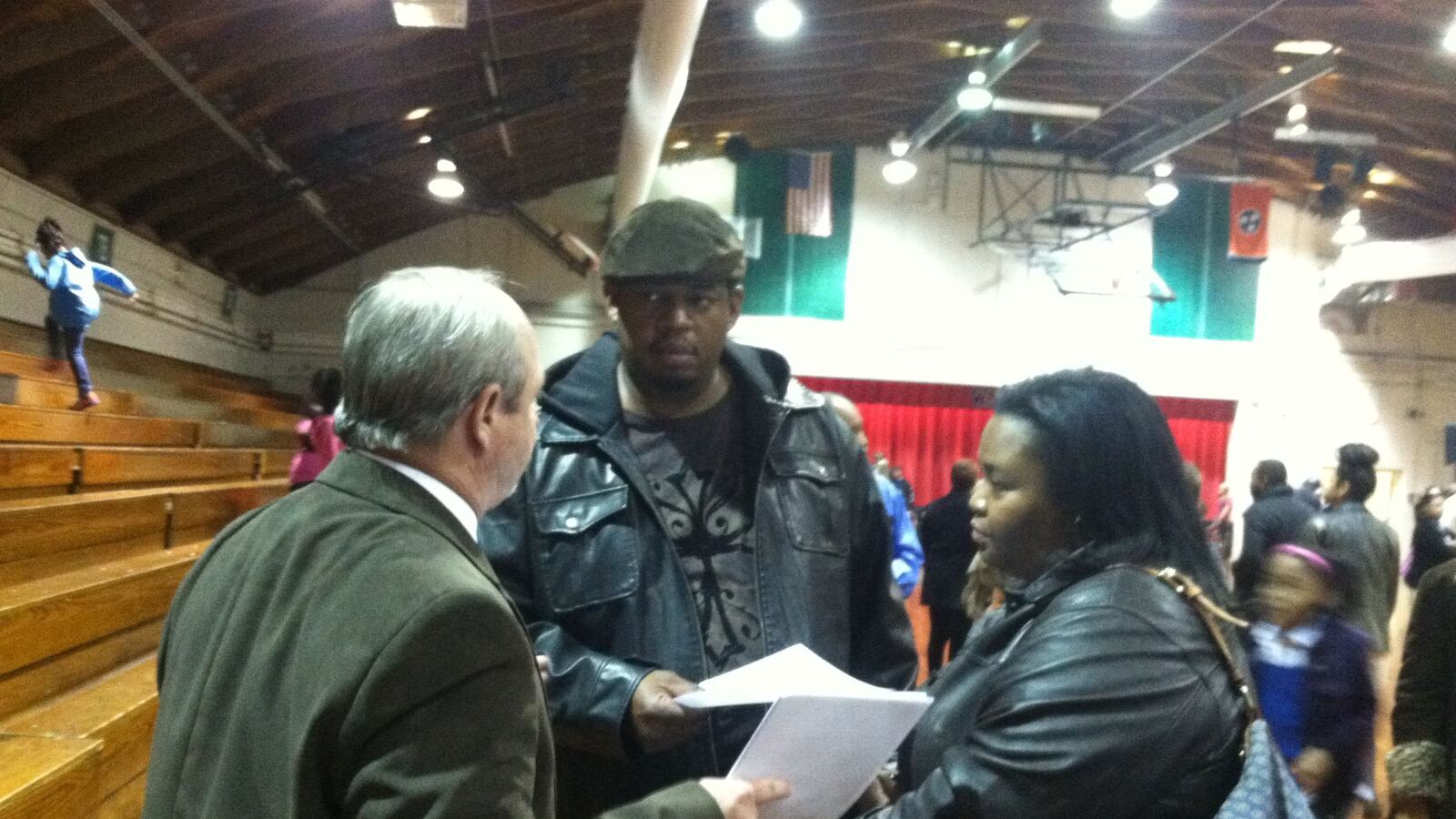 Millington school board member Cory Childress talks to parents at a Shelby County school board meeting.