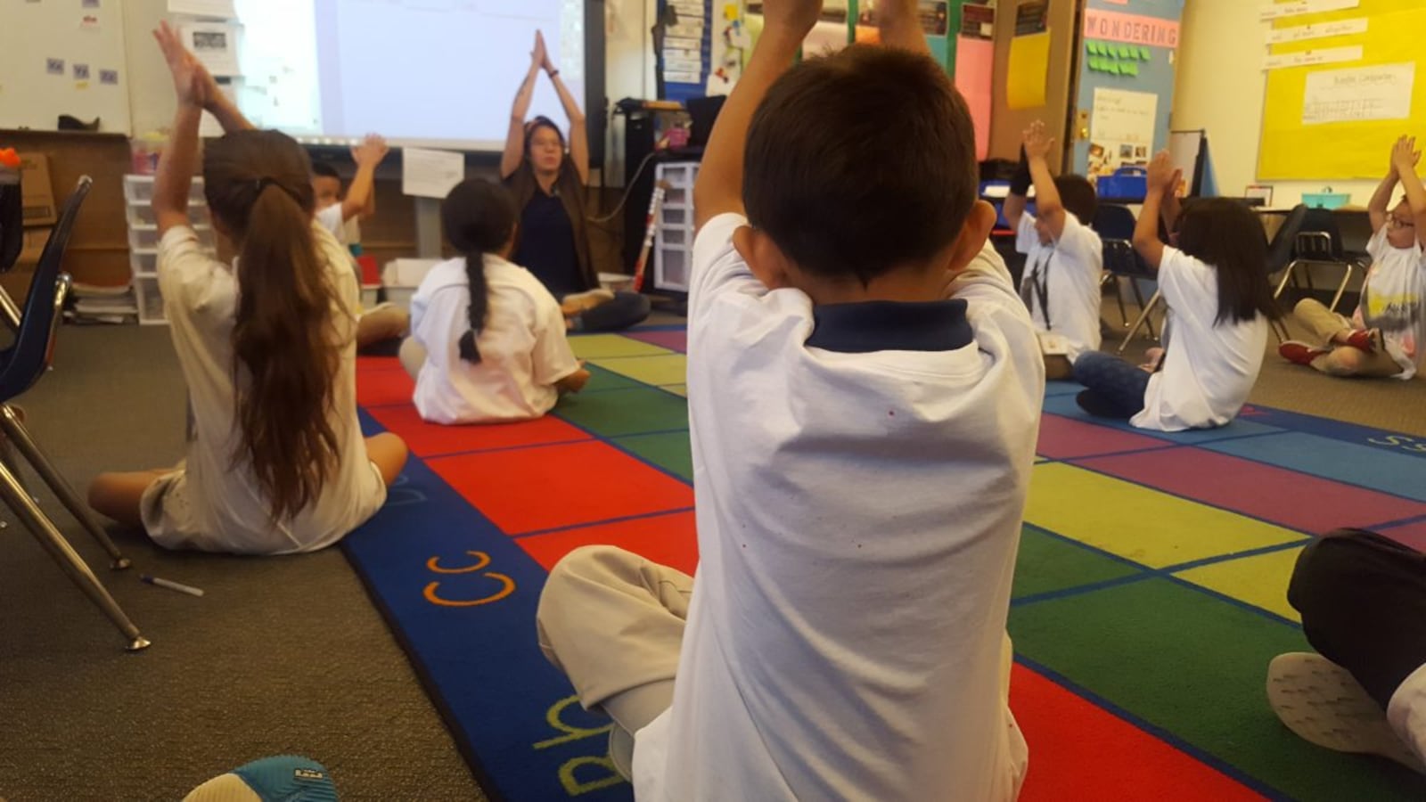 First graders do yoga during class Sept. 20, at Elkhart Elementary in Aurora.