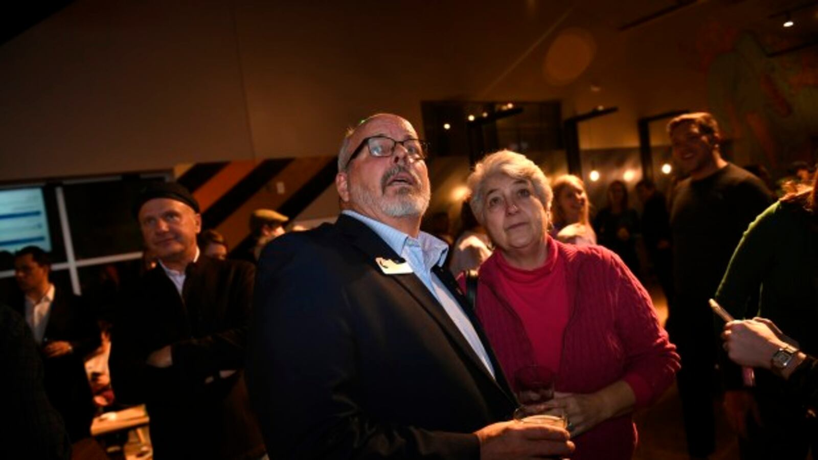 State Rep. Tom Sullivan, middle, and state Sen. Lois Court, right, watch as the numbers come in during a watch party for Proposition CC.