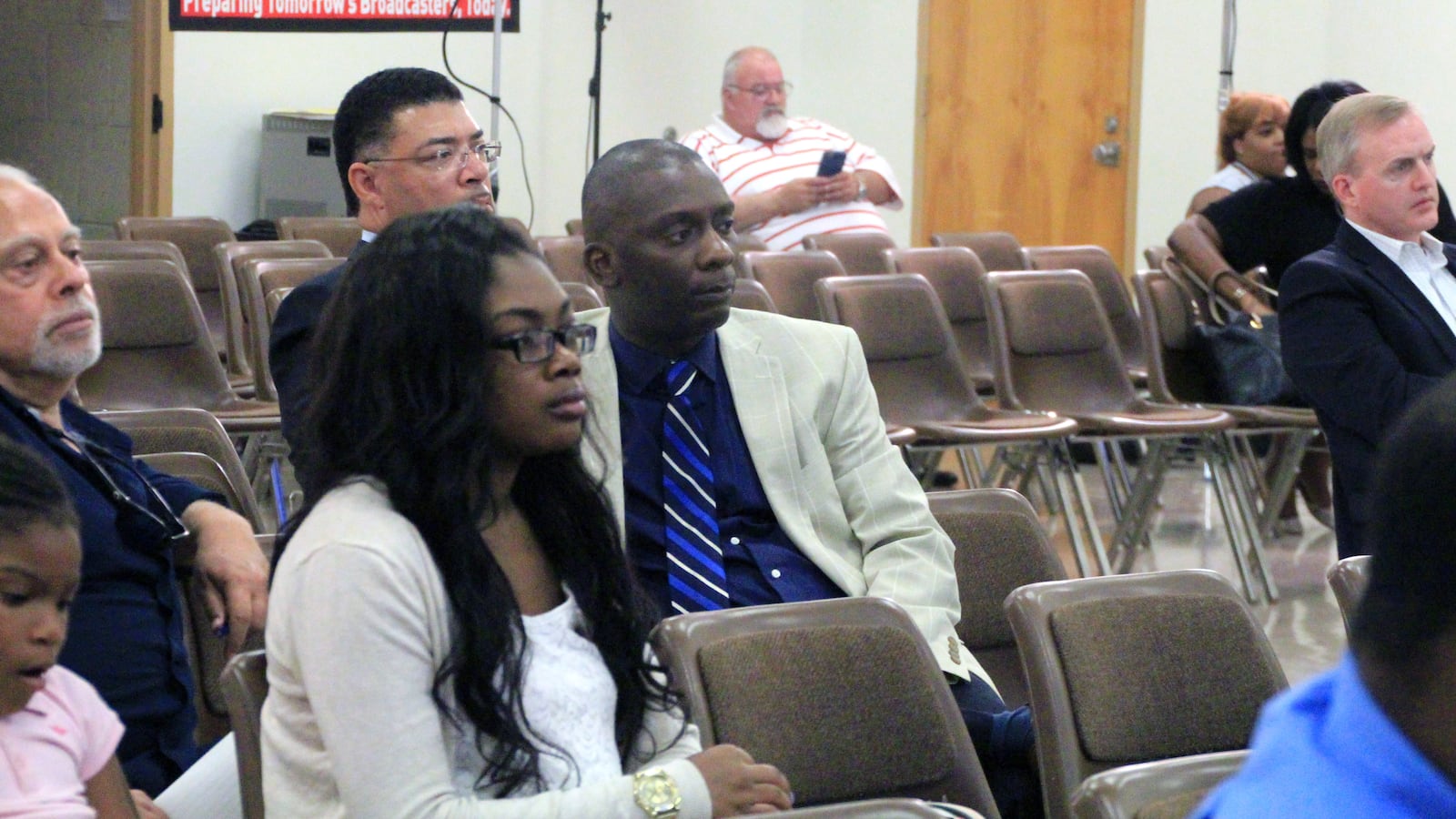 Tommie Henderson, executive director of the New Consortium of Law and Business, listens as district school board members discuss the future of the school.