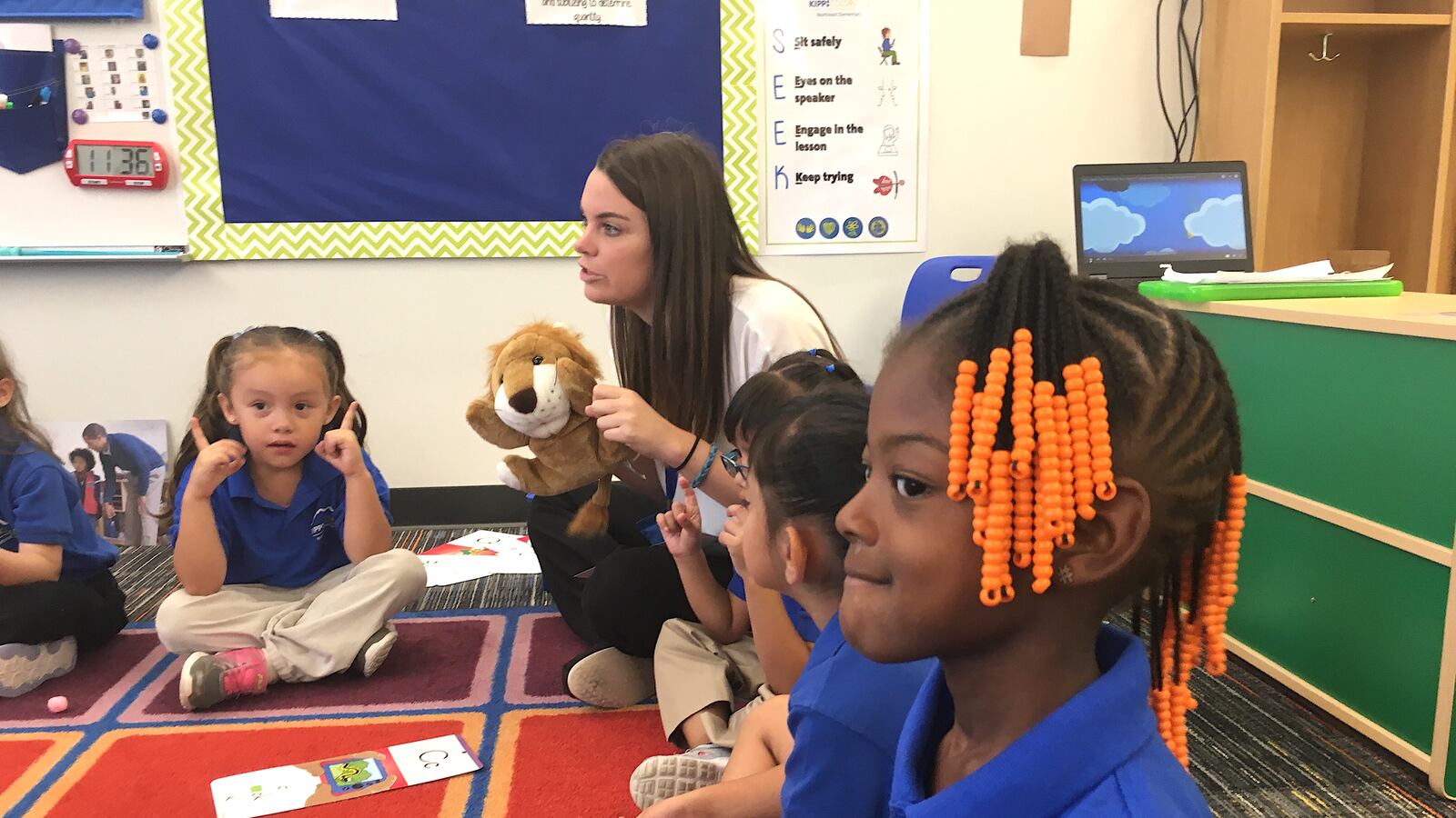 A preschool teacher at KIPP Northeast Elementary in  Denver, reviews letters with the help of "Phonics Lion."