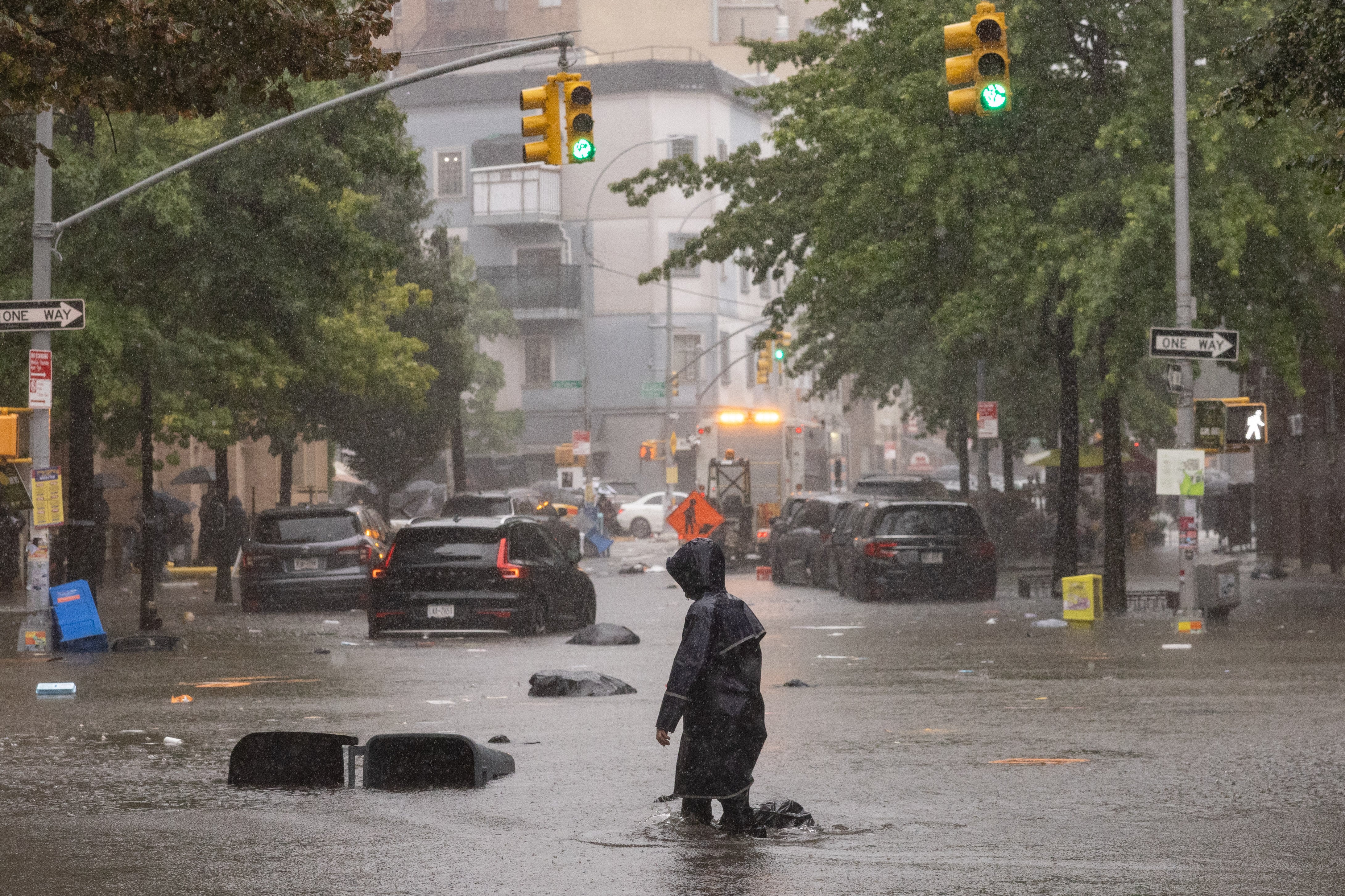 A flooded street with some cars partially under water