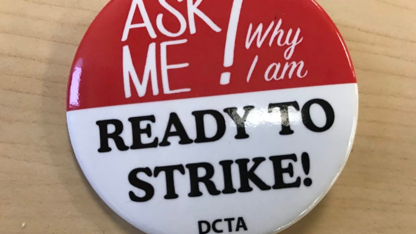 Some Denver teachers are wearing these buttons, provided by the union, at the teacher pay negotiations.