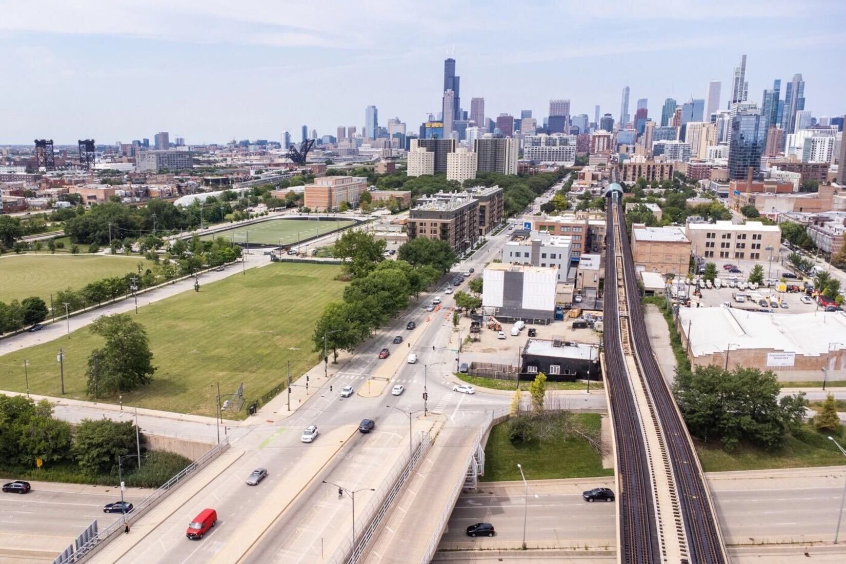 Overhead view of vacant lot with highways and roads in the foreground and the Chicago skyline in the background.