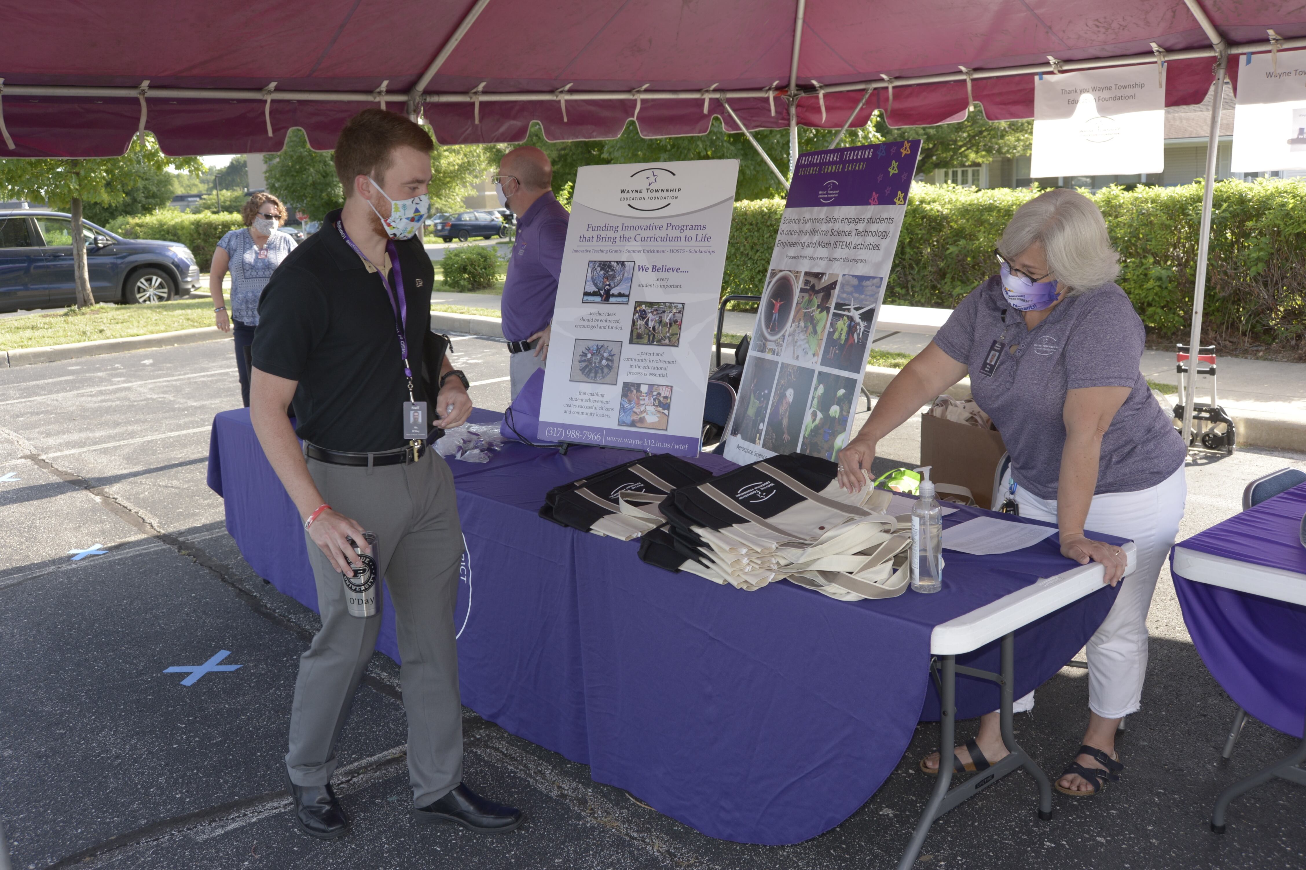New teacher Connor O’Day picks up classroom supplies from a Wayne Township orientation event.