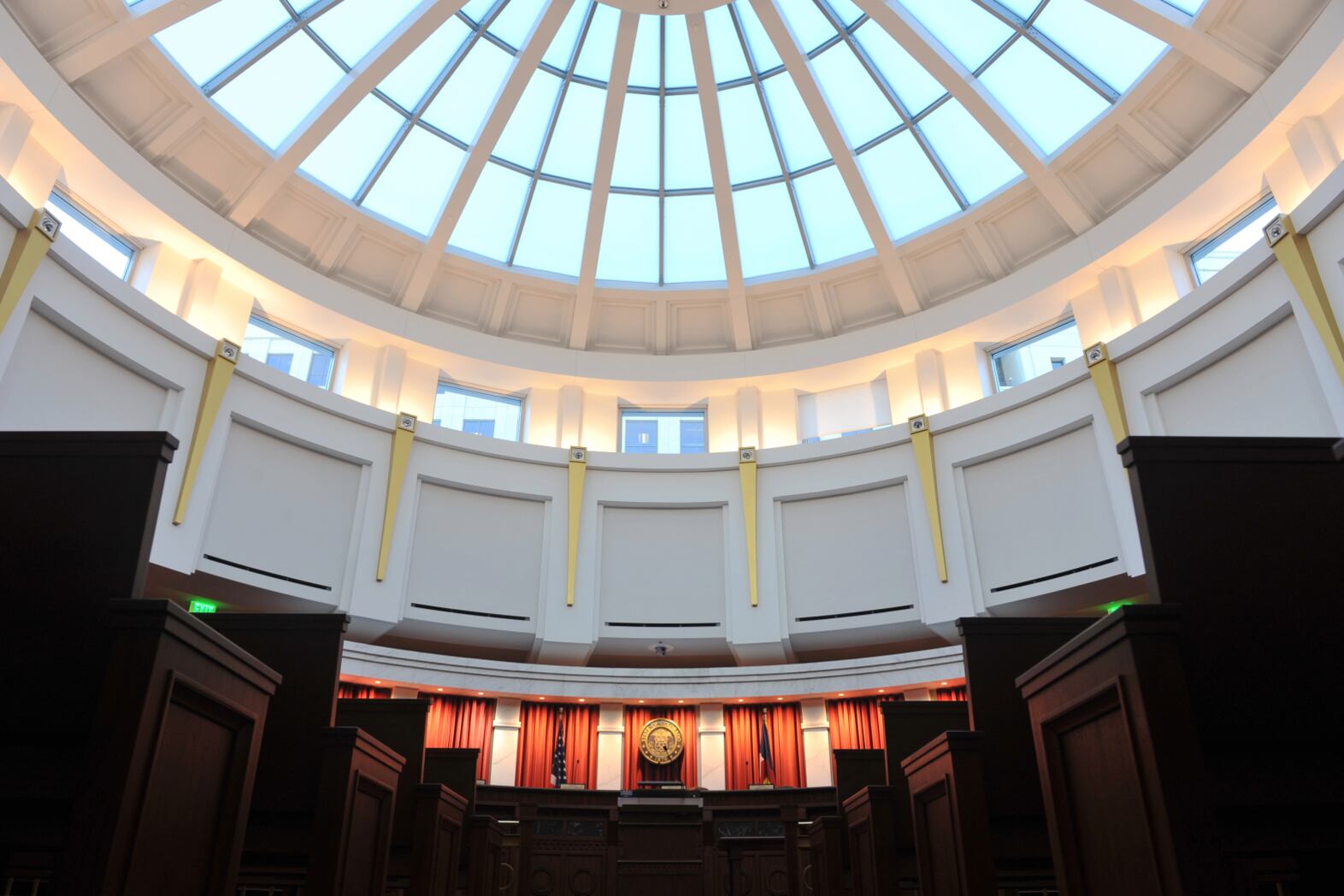Photo shows half the pale blue glass dome and the upper level of the Colorado Supreme Court chambers at the Ralph Carr Judicial Center in Denver, Colorado.