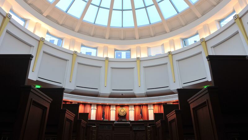 Photo shows half the pale blue glass dome and the upper level of the Colorado Supreme Court chambers at the Ralph Carr Judicial Center in Denver, Colorado.
