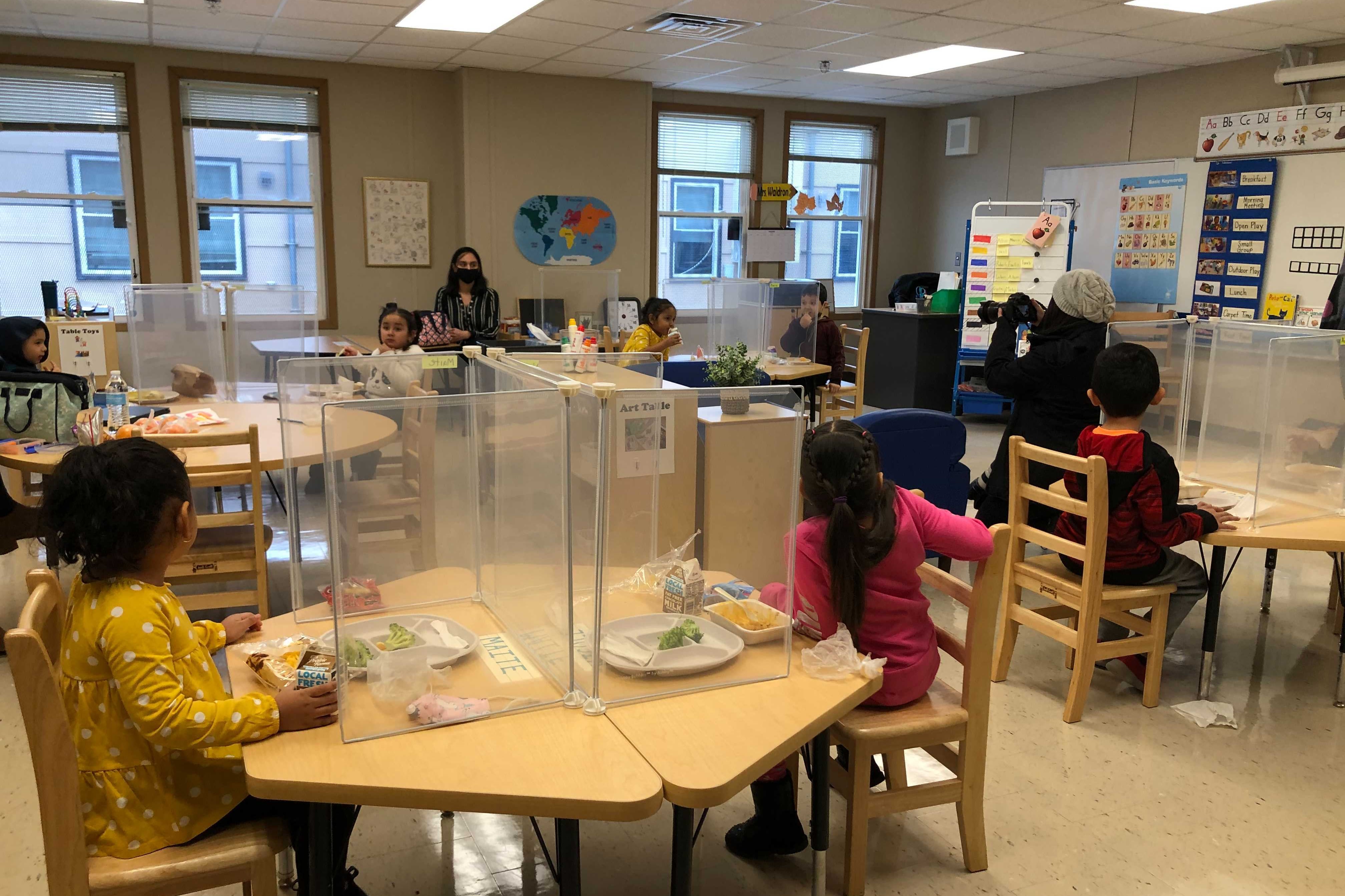 Students eat lunch behind Plexiglass shields at Dawes Elementary in Chicago’s Ashburn neighborhood. Chicago reopened schools Monday to about 6,000 students despite opposition to the plan from its teachers’ union.