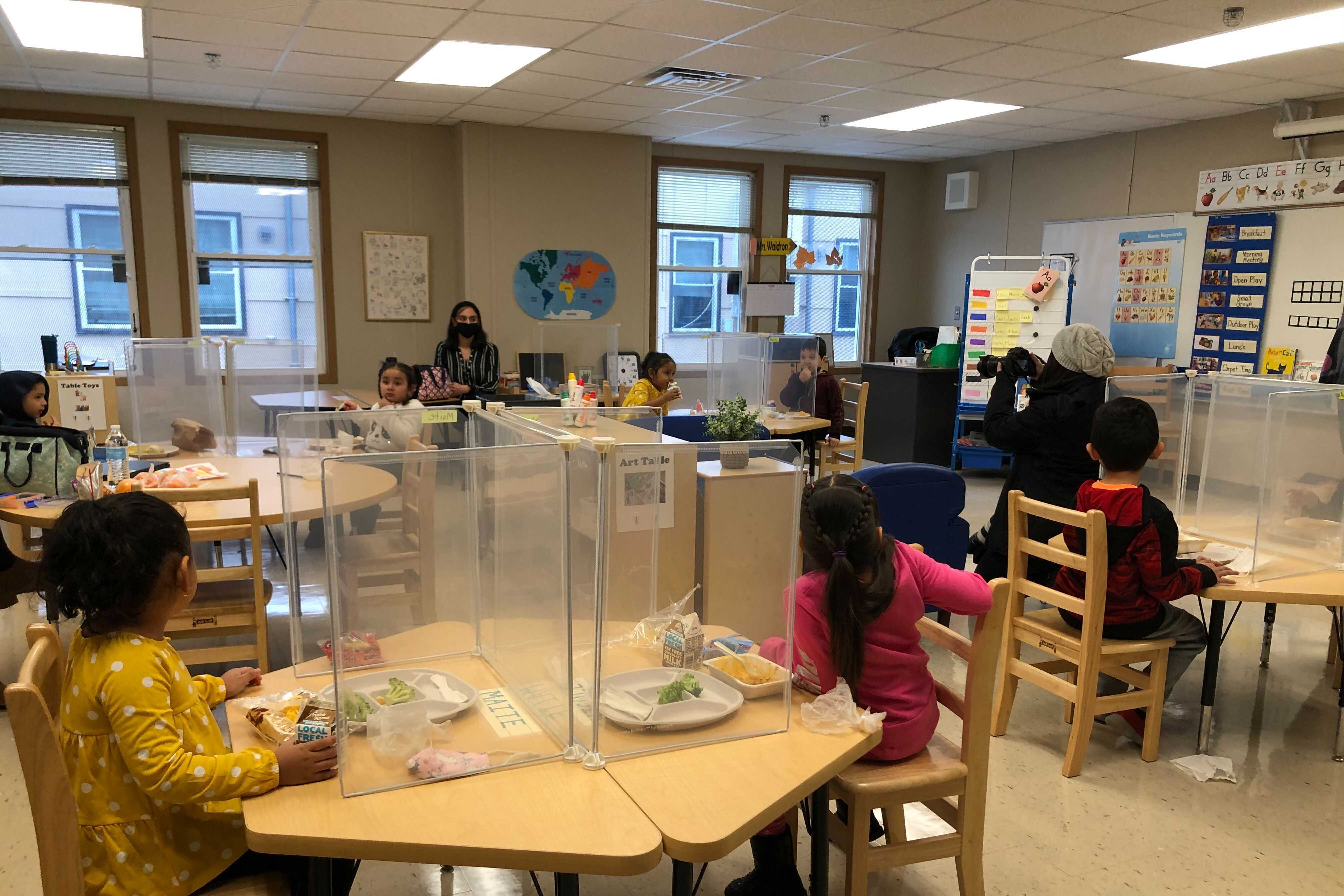 Students eat lunch behind Plexiglass shields at Dawes Elementary in Chicago’s Ashburn neighborhood. Chicago reopened schools Monday to about 6,000 students despite opposition to the plan from its teachers’ union.