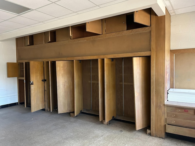 A room with empty wooden shelves.