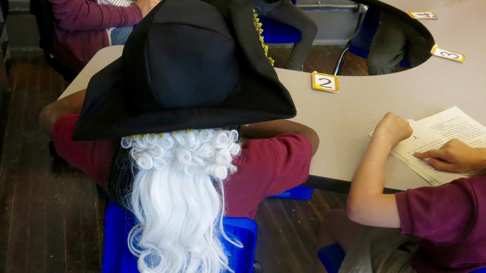 A first-grader at Nashville Classical Charter School wears a Colonial-era hat after history class. A new proposal would require all Tennessee students take a full semester of state-specific history at some point in their education.