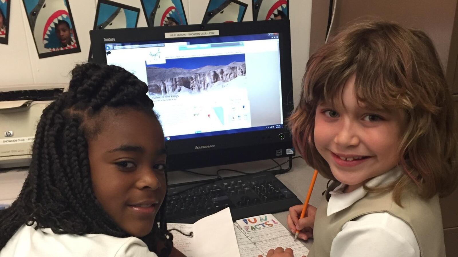 From left: Students India Turner and Nina Crespo do online research for an ancient Egypt “travel guide” during a CLUE class at Snowden School in Memphis.