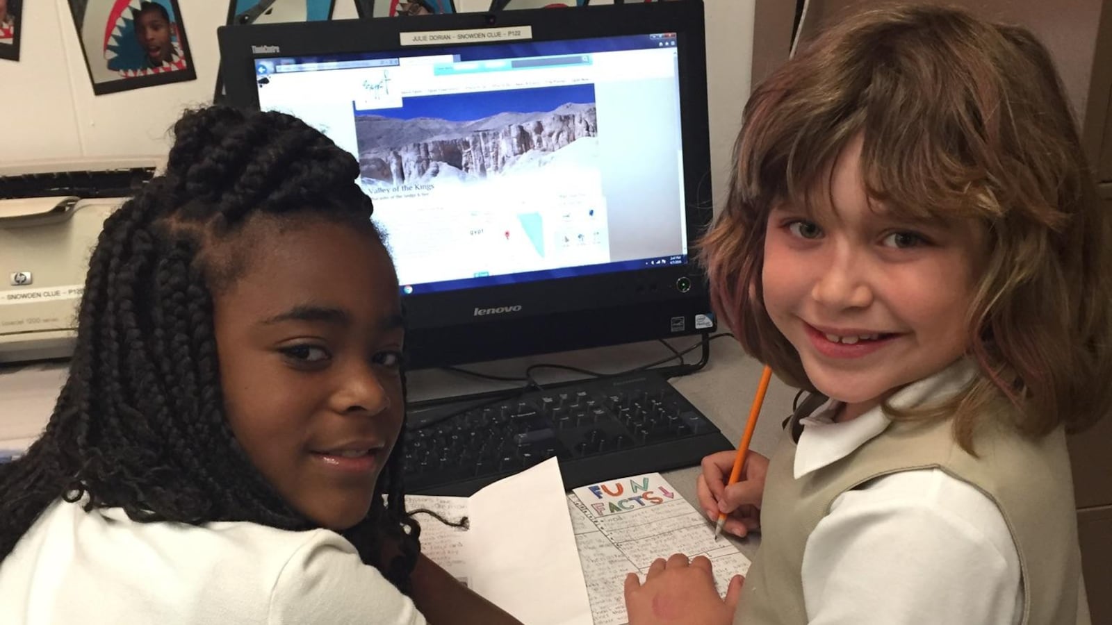 From left: Students India Turner and Nina Crespo do online research for an ancient Egypt “travel guide” during a CLUE class at Snowden School in Memphis.