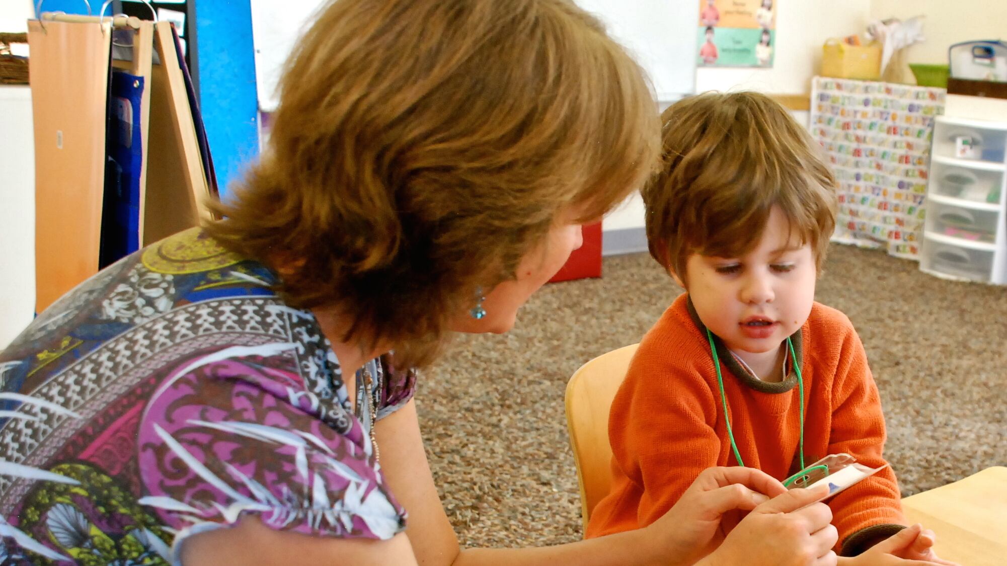 Speech therapist Melissa Cain talks to a preschooler at the Bal Swan Children’s Center.