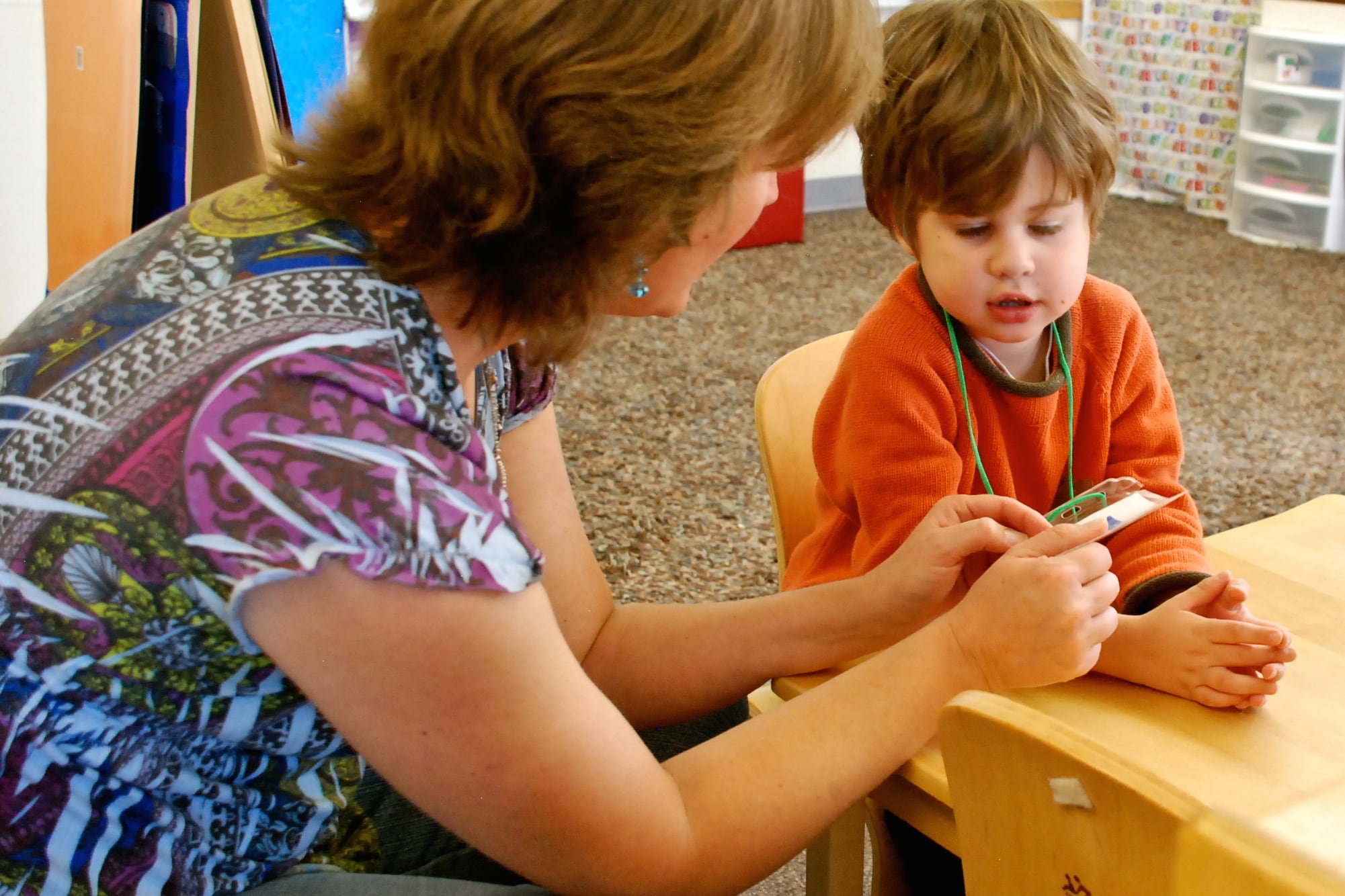 Speech therapist Melissa Cain talks to a preschooler at the Bal Swan Children’s Center.
