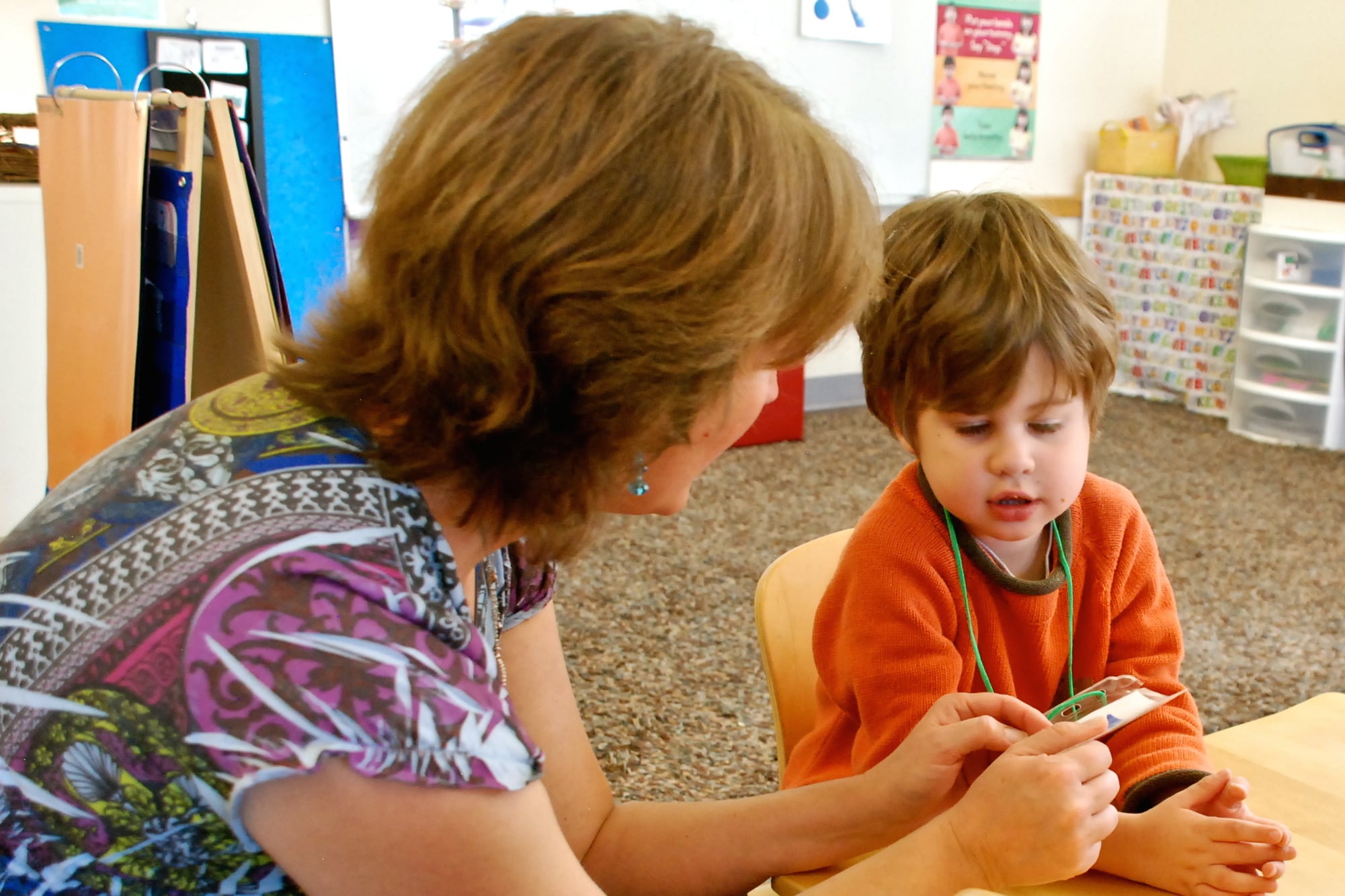 Speech therapist Melissa Cain talks to a preschooler at the Bal Swan Children’s Center.
