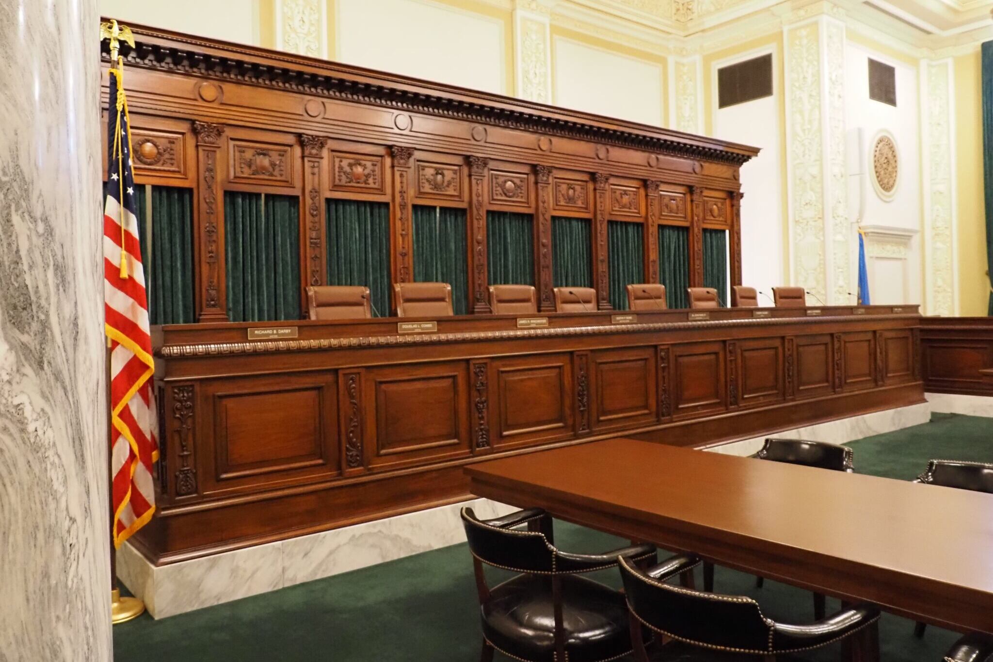 Oklahoma Supreme Court chambers showing ornate wooden seating but no justices.