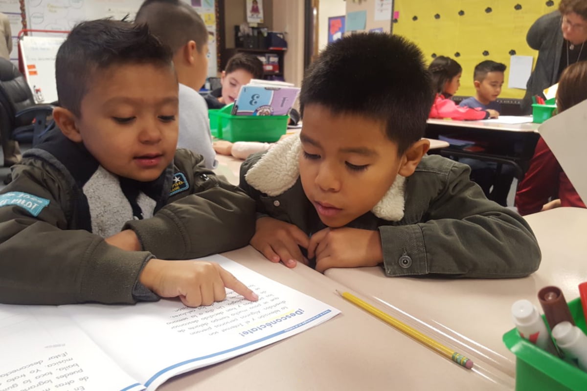 First grade students practice reading in Spanish in their biliteracy classroom at Dupont Elementary School in Adams 14.