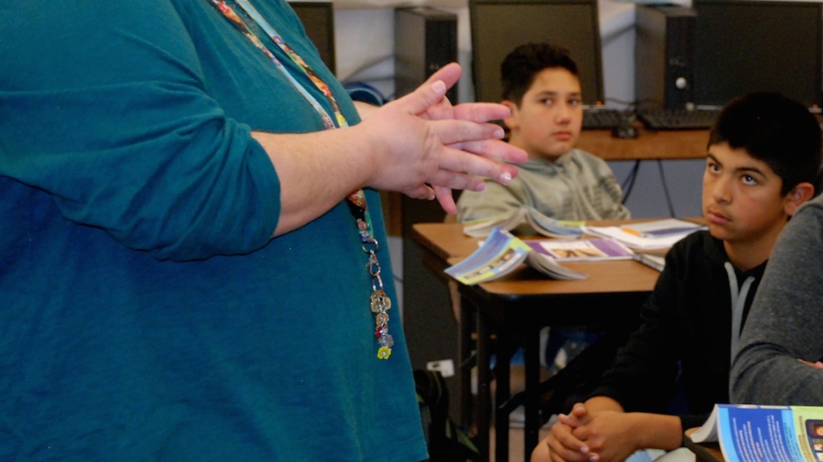 Eighth grade reading teacher Leslie Fitzgerald, left, discusses a short story with her class Thursday. One discussion question: How did the mother's narrator compare to other adult figures in earlier short stories the students have read?